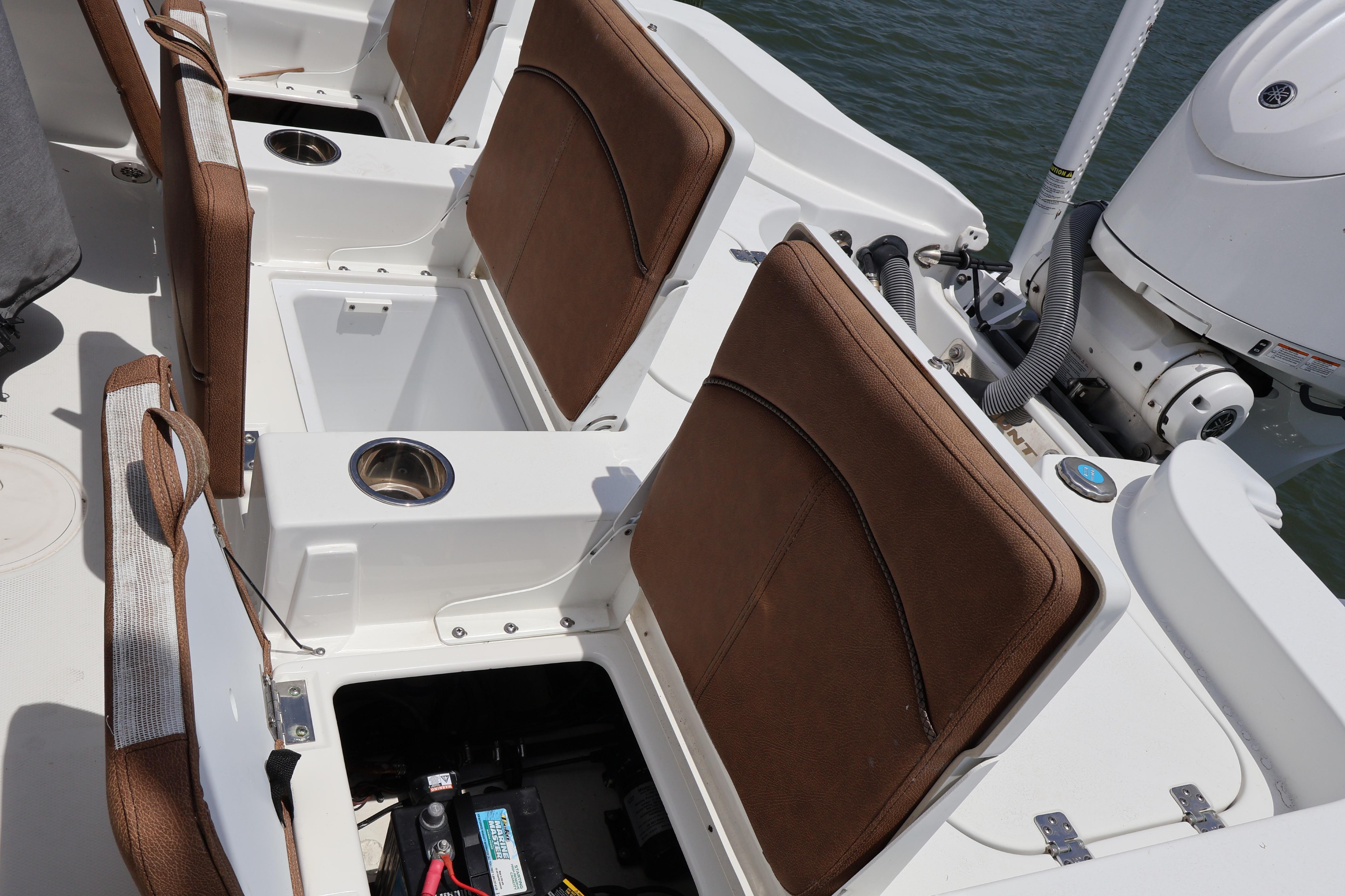 2022 Sea Hunt BX 25 FS boat interior with brown seats and storage compartments.