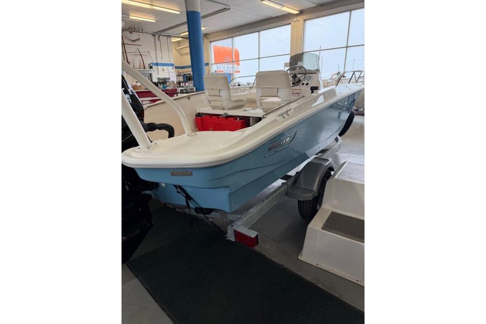 2026 Boston Whaler 160 Super Sport boat in showroom, on trailer.