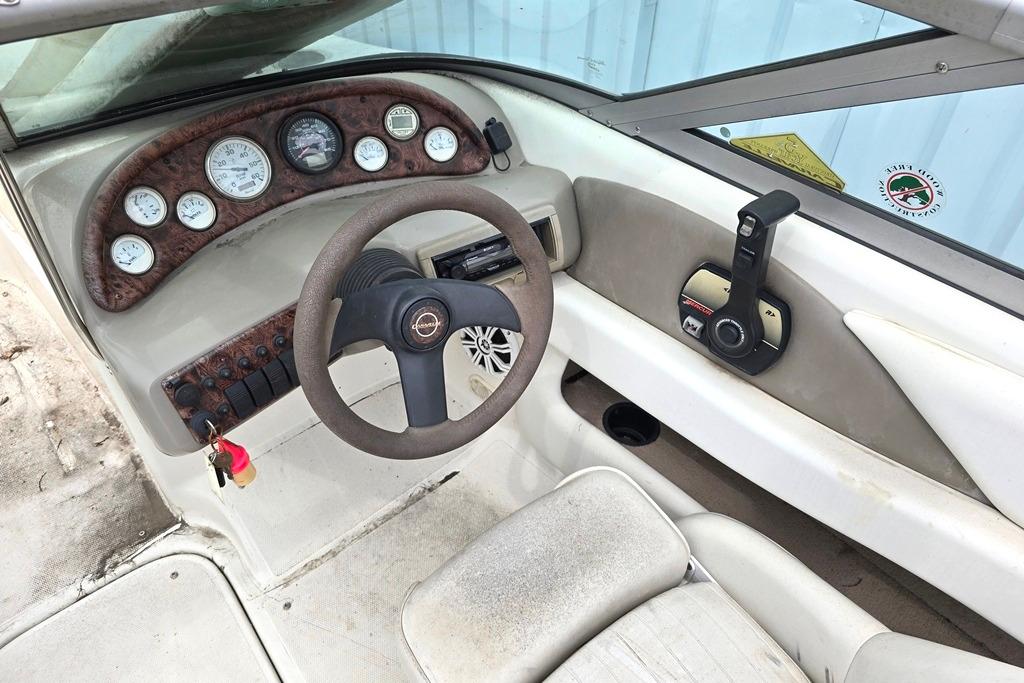 Interior of a 2003 Caravelle 187 Bow Rider boat showing steering wheel and dashboard controls.