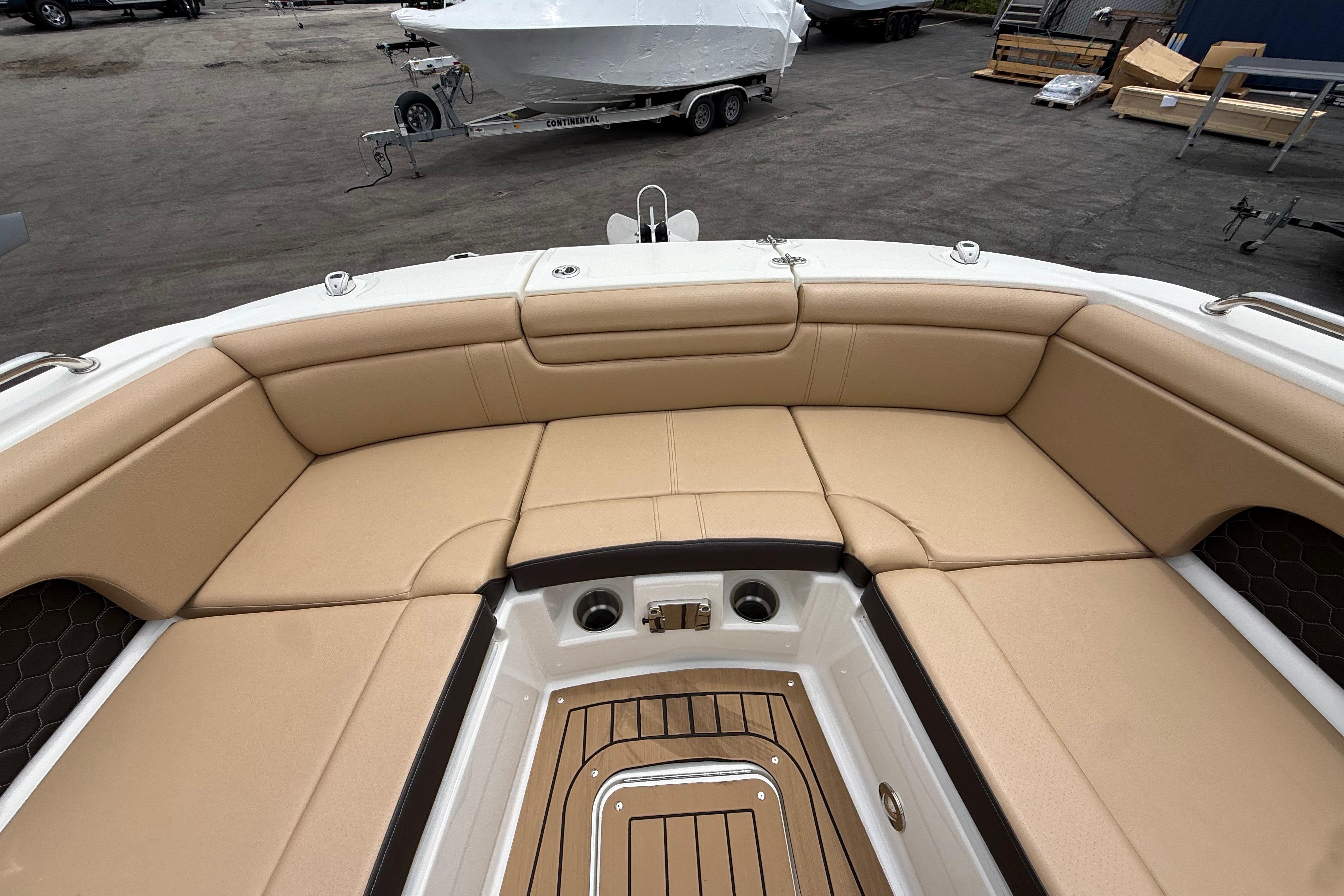 2022 Sea Ray SDX 290 Outboard boat interior with tan seating and teak flooring.