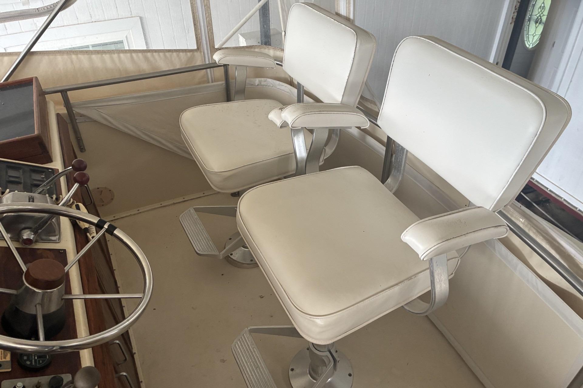 Captain's chairs and helm on 1980 Chris-Craft 360 Commander boat.