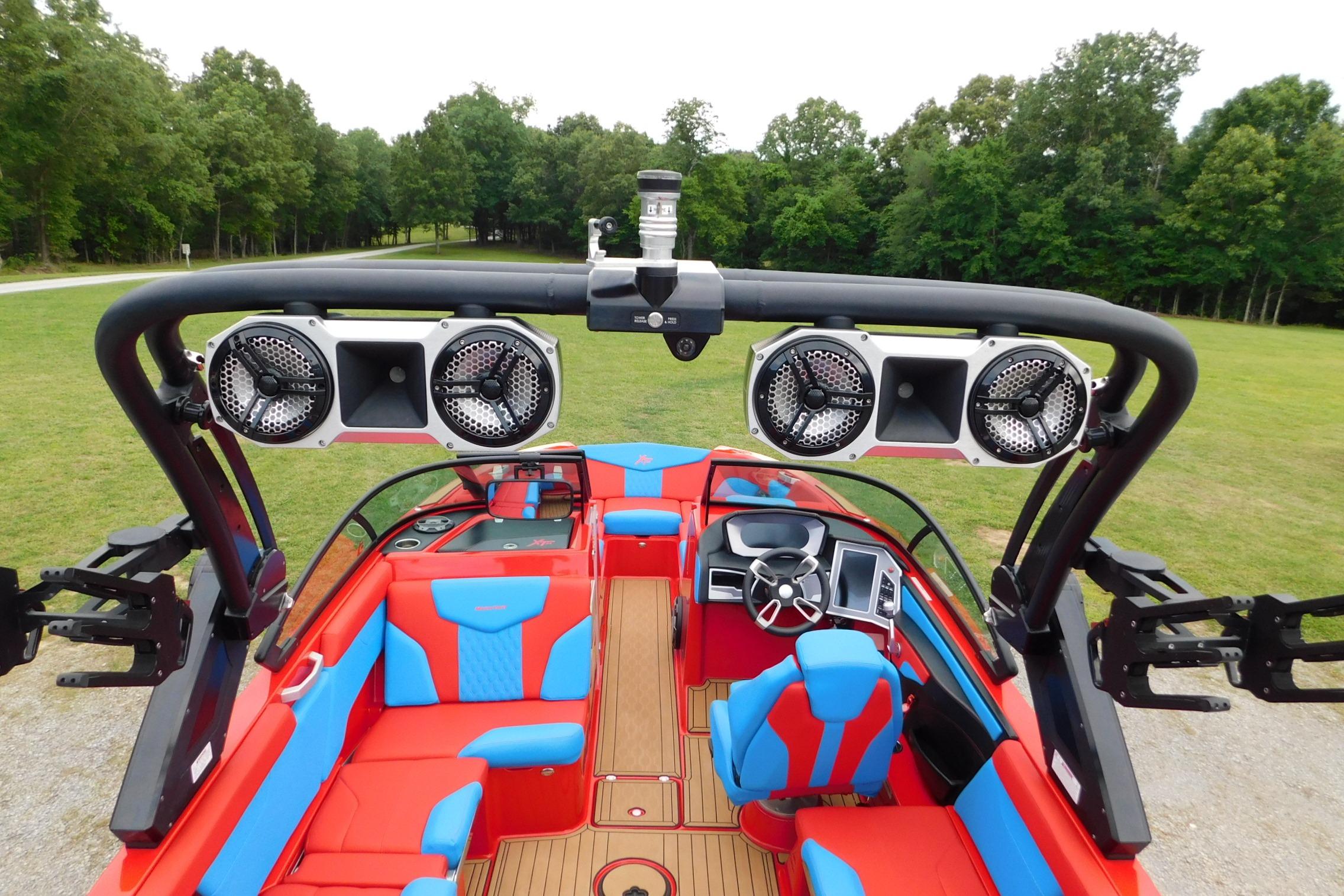 2022 MasterCraft NXT24 boat interior with vibrant red and blue seating, advanced sound system.