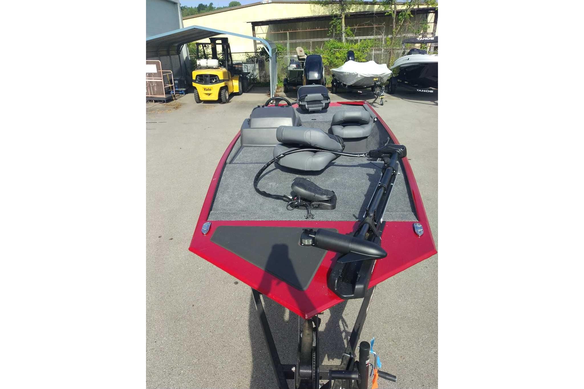 2026 Tracker Bass Tracker Classic XL boat with red and gray design, parked outdoors.