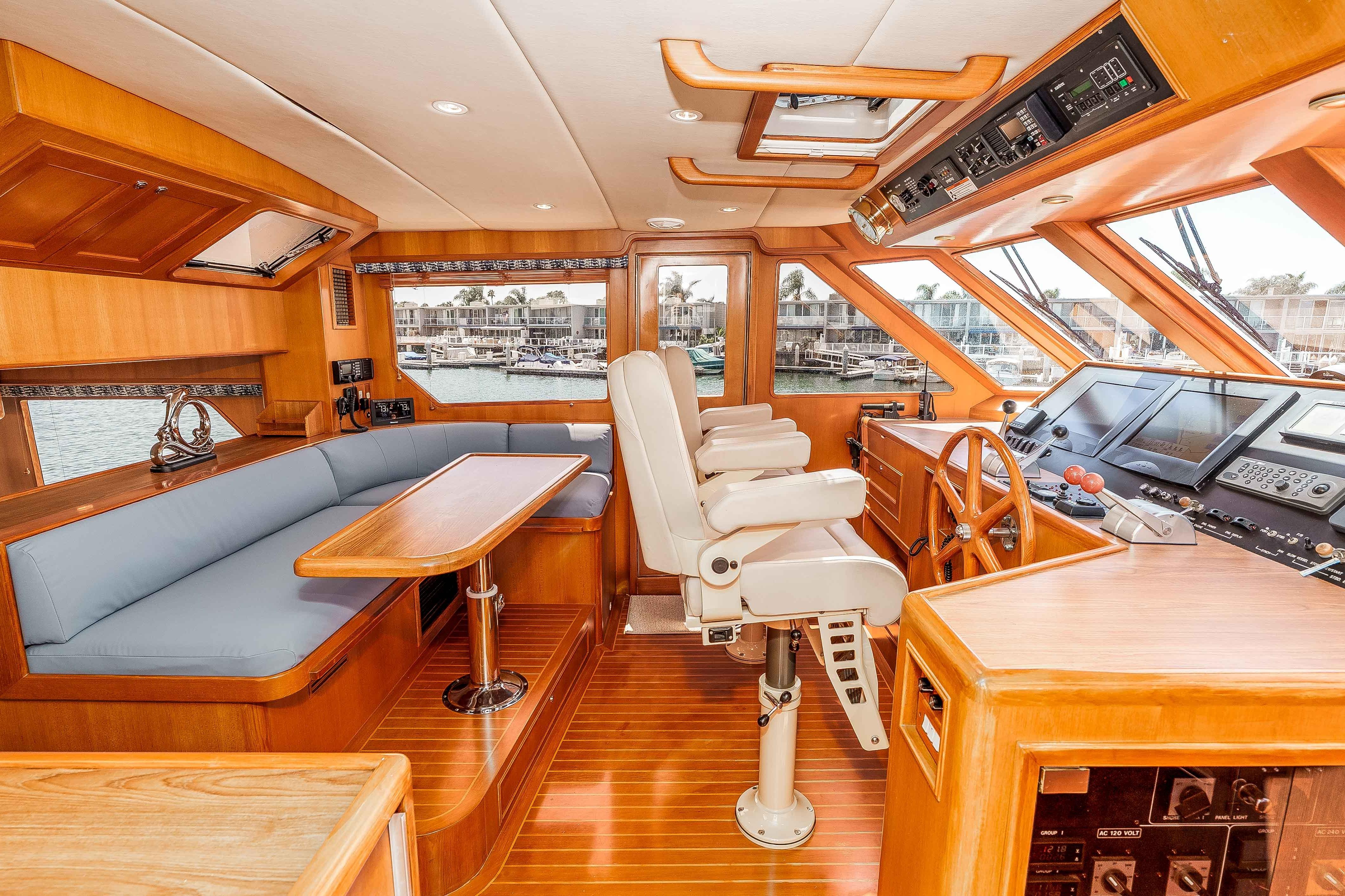 Luxurious 2005 Offshore Yachts 54 Pilothouse interior with helm, seating, and navigation equipment.