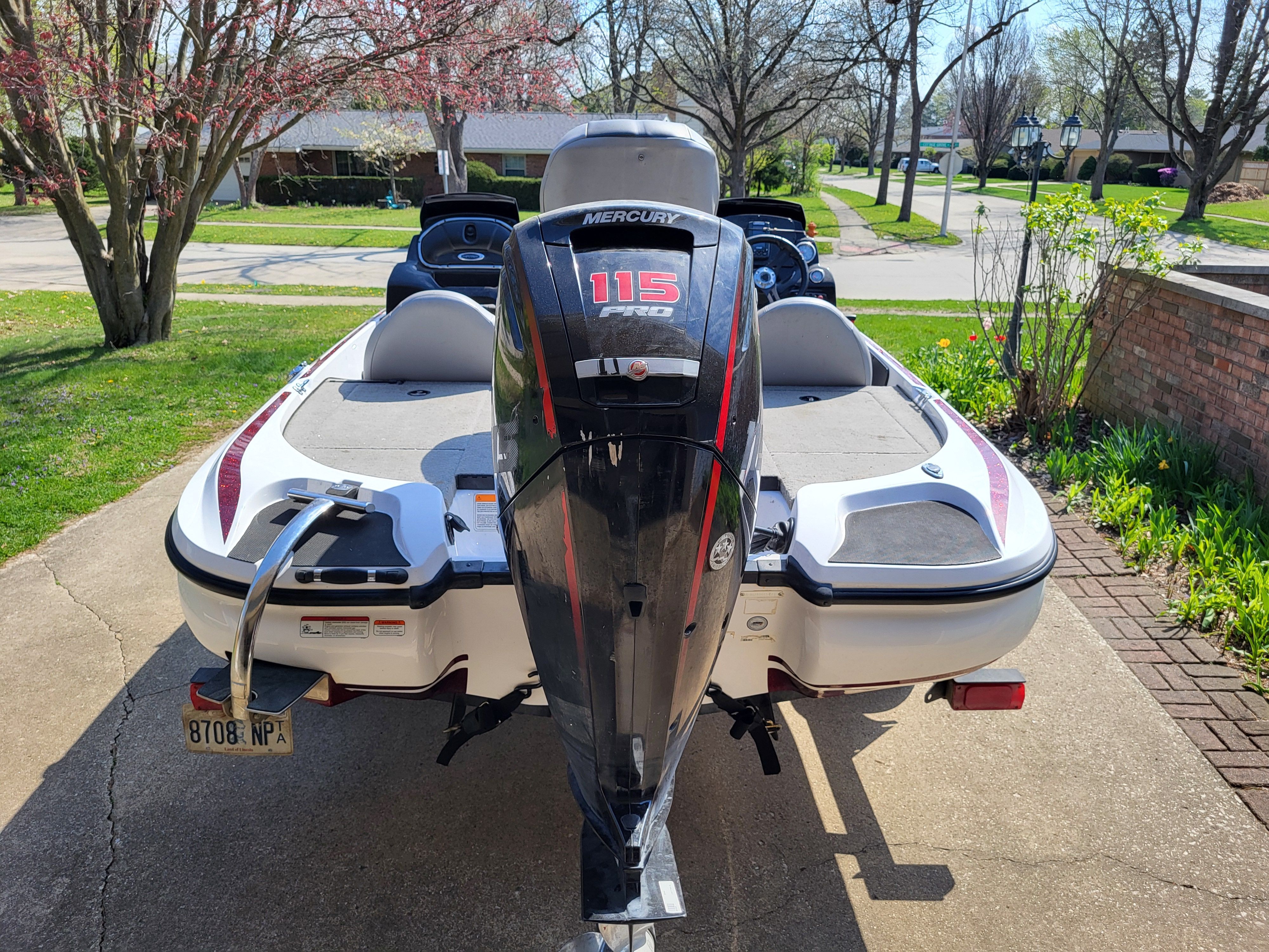 A 2017 Nitro Z17 boat with a Mercury 115 HP outboard motor, parked in a driveway.