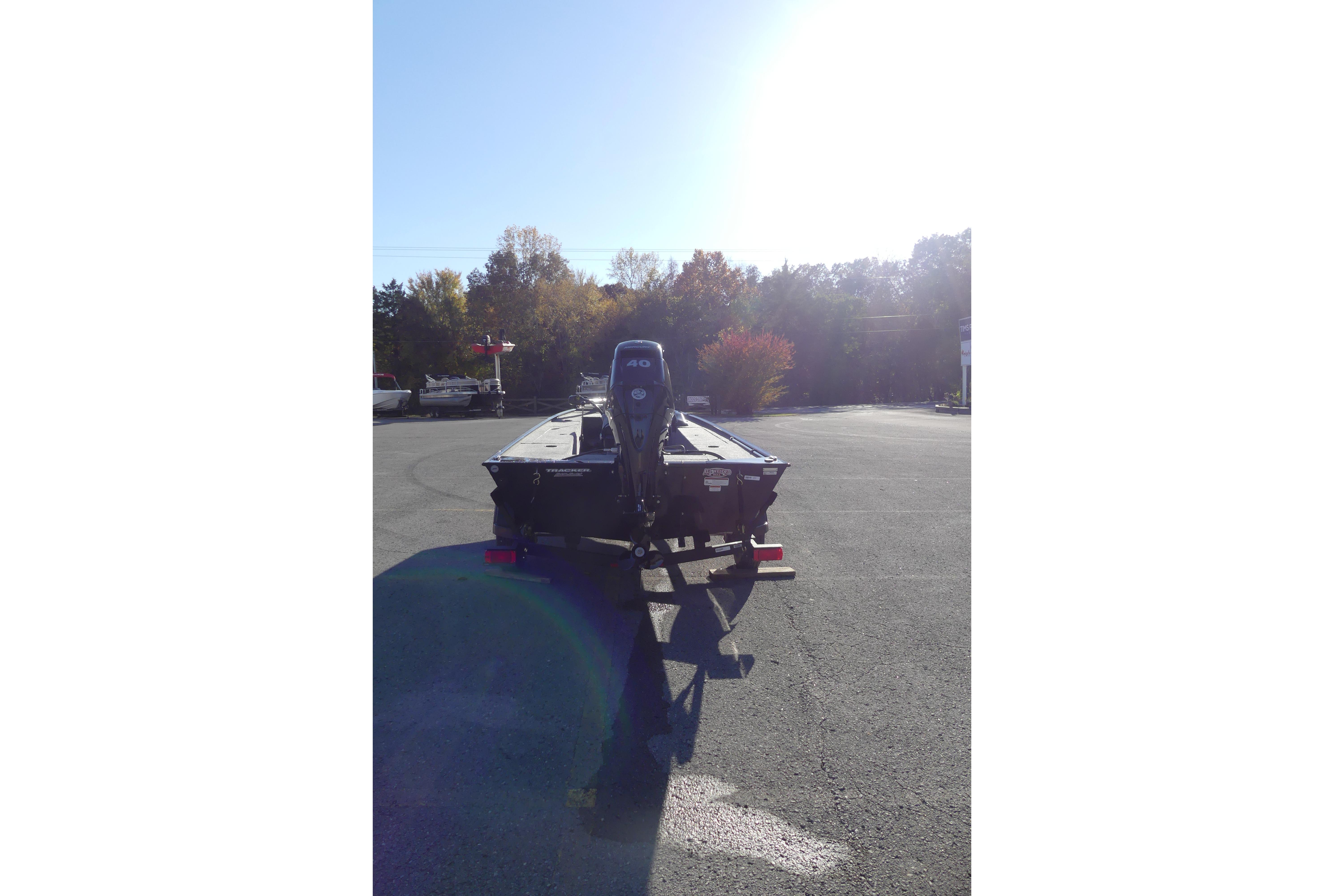2025 Tracker Panfish 17 boat with outboard motor in a parking lot.