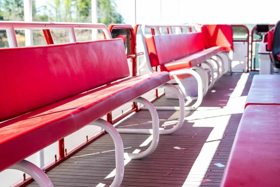 Red seating on 2024 Aloha Pontoon 50' Water Taxi, featuring spacious interior design.