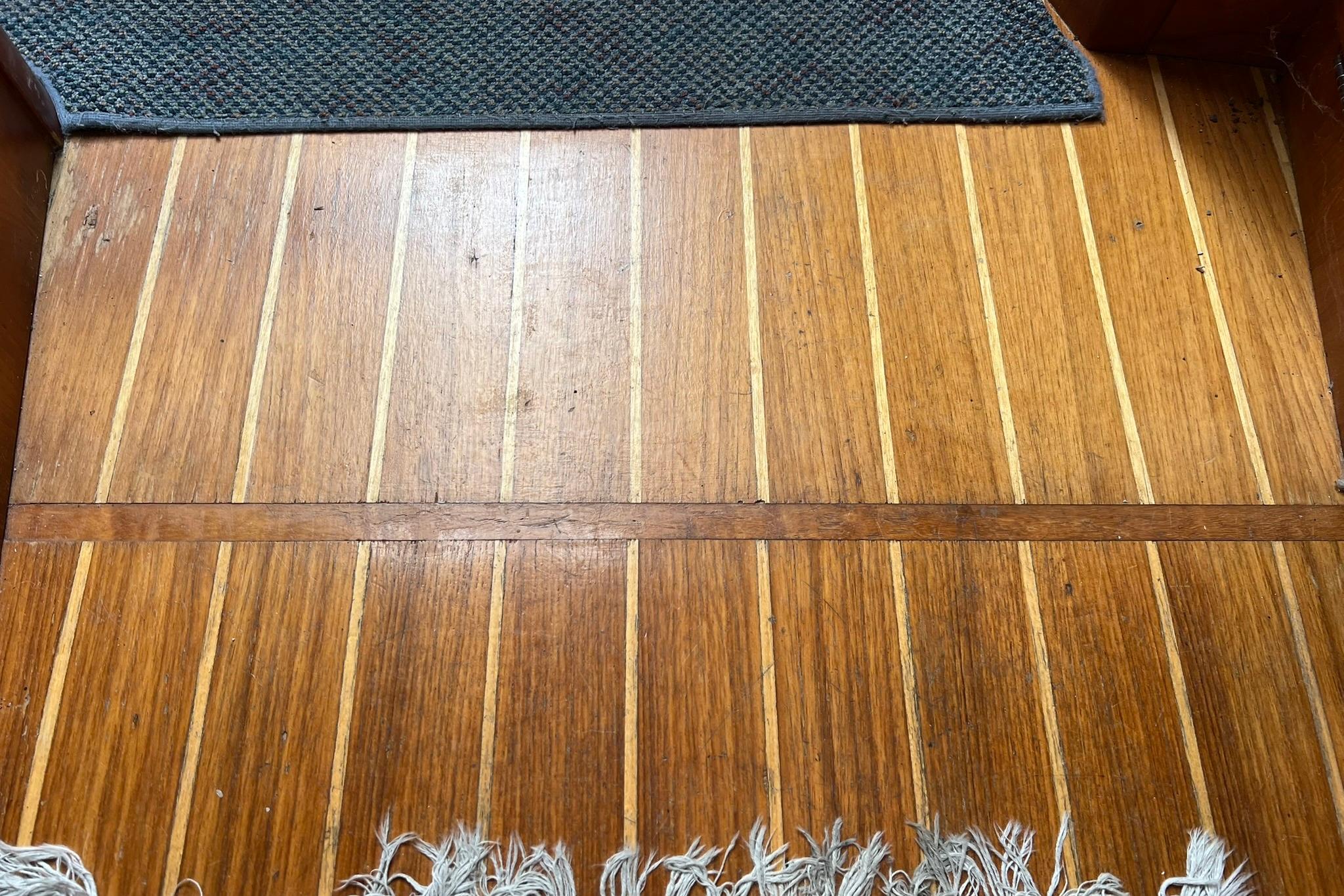 Teak wood flooring on a 1998 Sabre 362 boat, with a textured mat.
