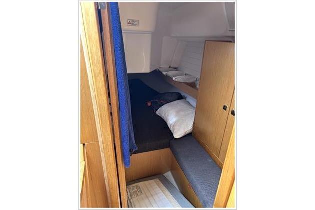 Cozy cabin interior of 2017 Bavaria 34 Cruiser sailboat with wooden furnishings.