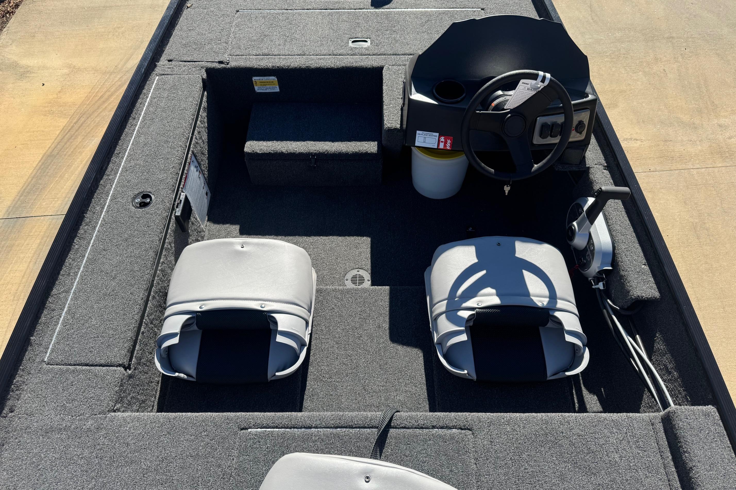 2026 Crestliner 1600 Storm boat interior with steering wheel and seating.