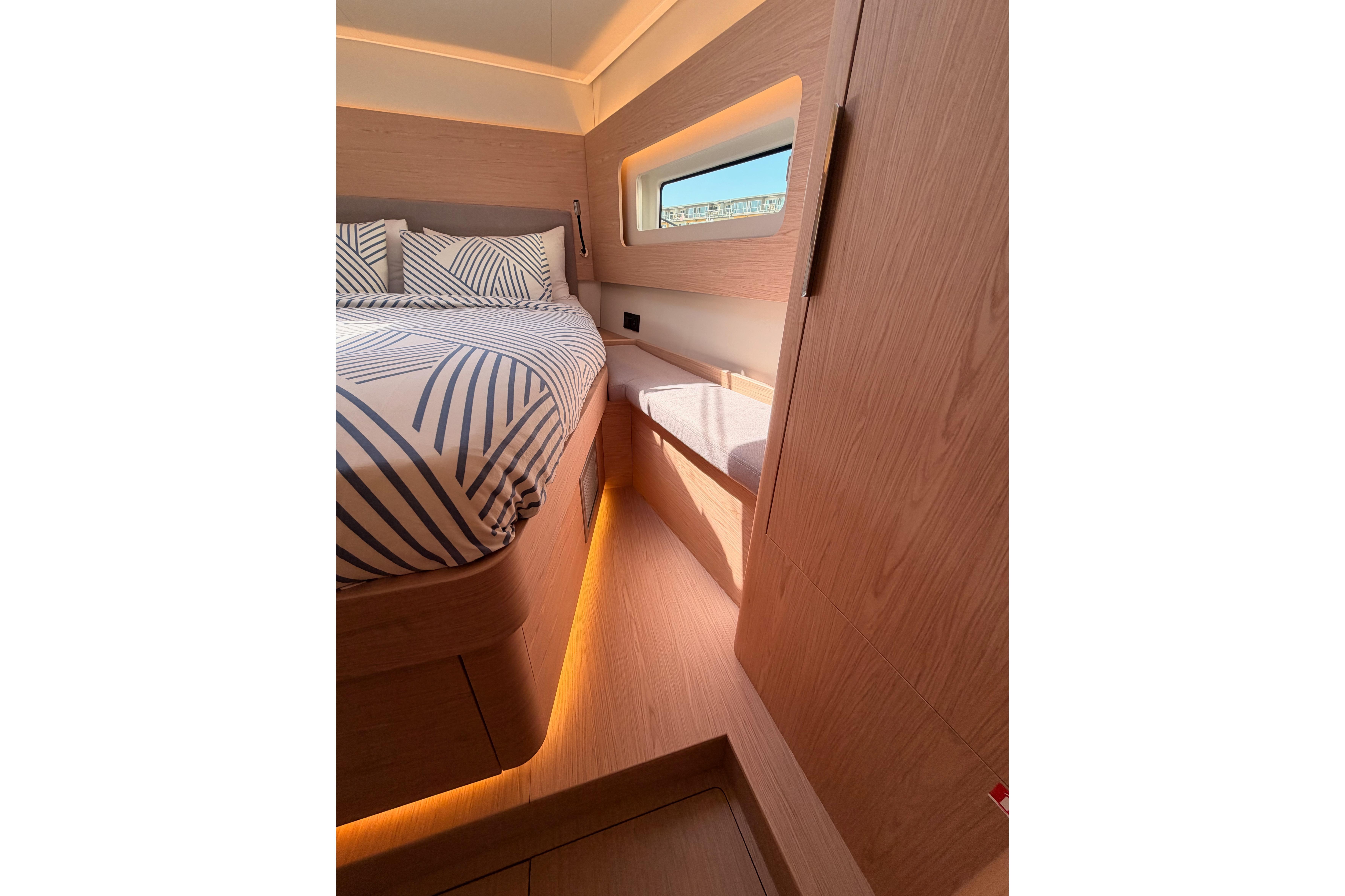 Luxurious cabin interior of 2022 Beneteau Oceanis Yacht 54 with modern design and ambient lighting.
