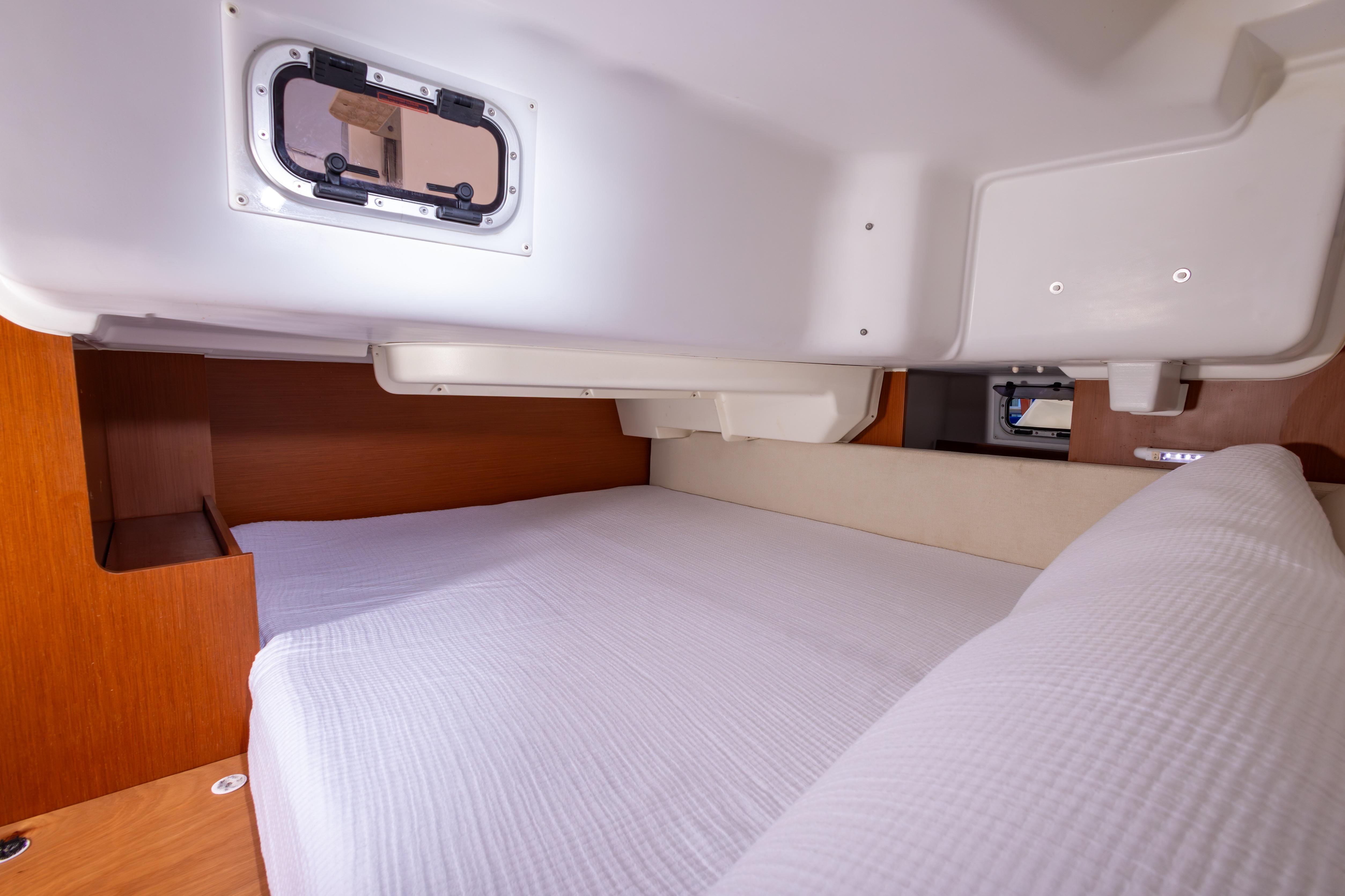 Cozy cabin interior of 2015 Beneteau Oceanis 37 sailboat with comfortable bedding.