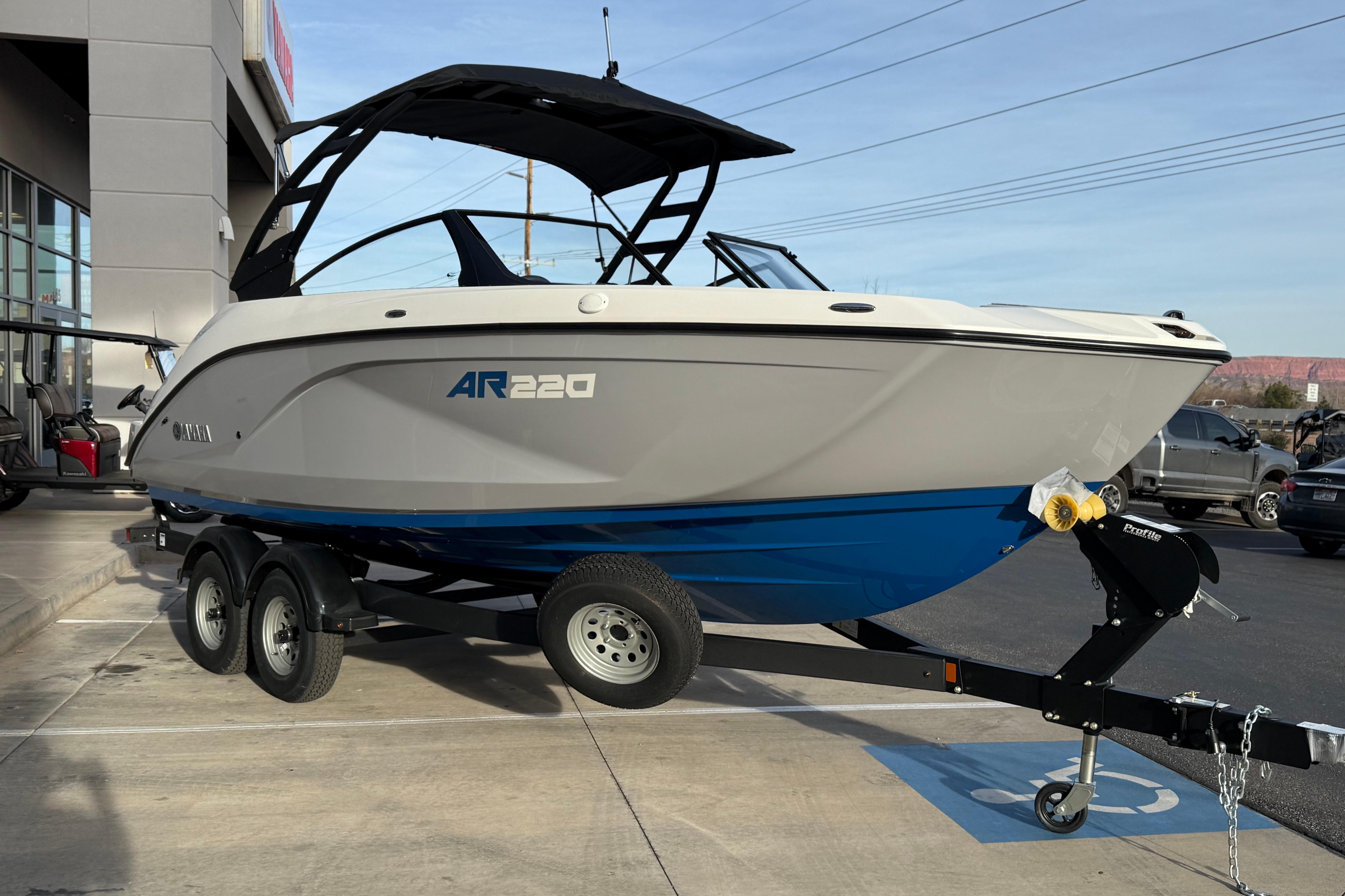 2026 Yamaha Boats AR220 on trailer, parked outdoors, showcasing sleek design and modern features.