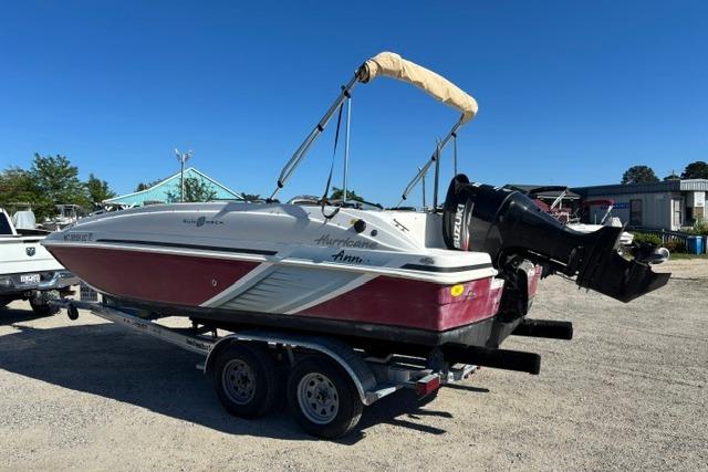 2016 Hurricane SunDeck Sport 188 OB boat on trailer, featuring a red and white design.