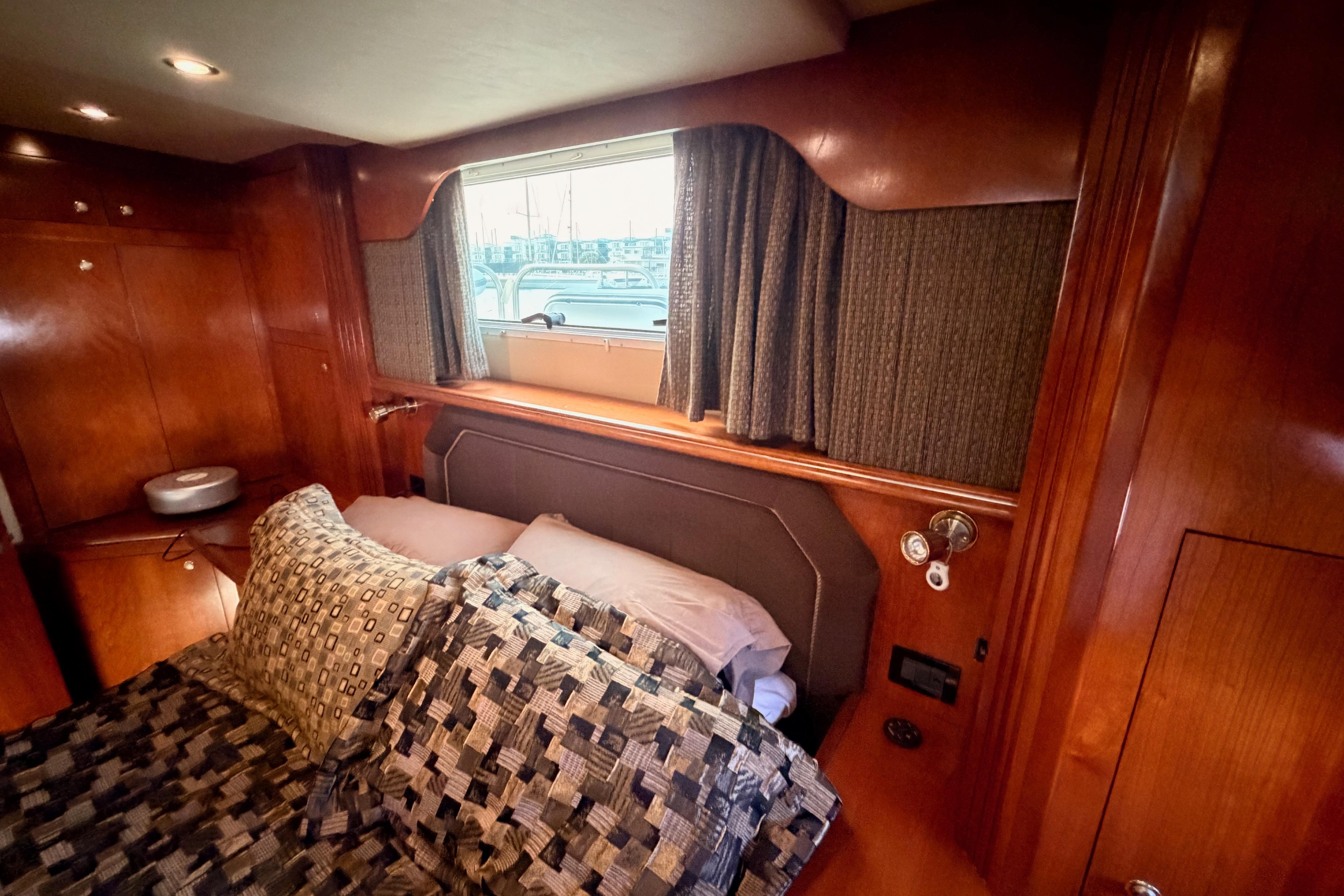 Luxurious cabin interior of 2005 Cruisers Yachts 405 Express Motoryacht with cozy bedding.