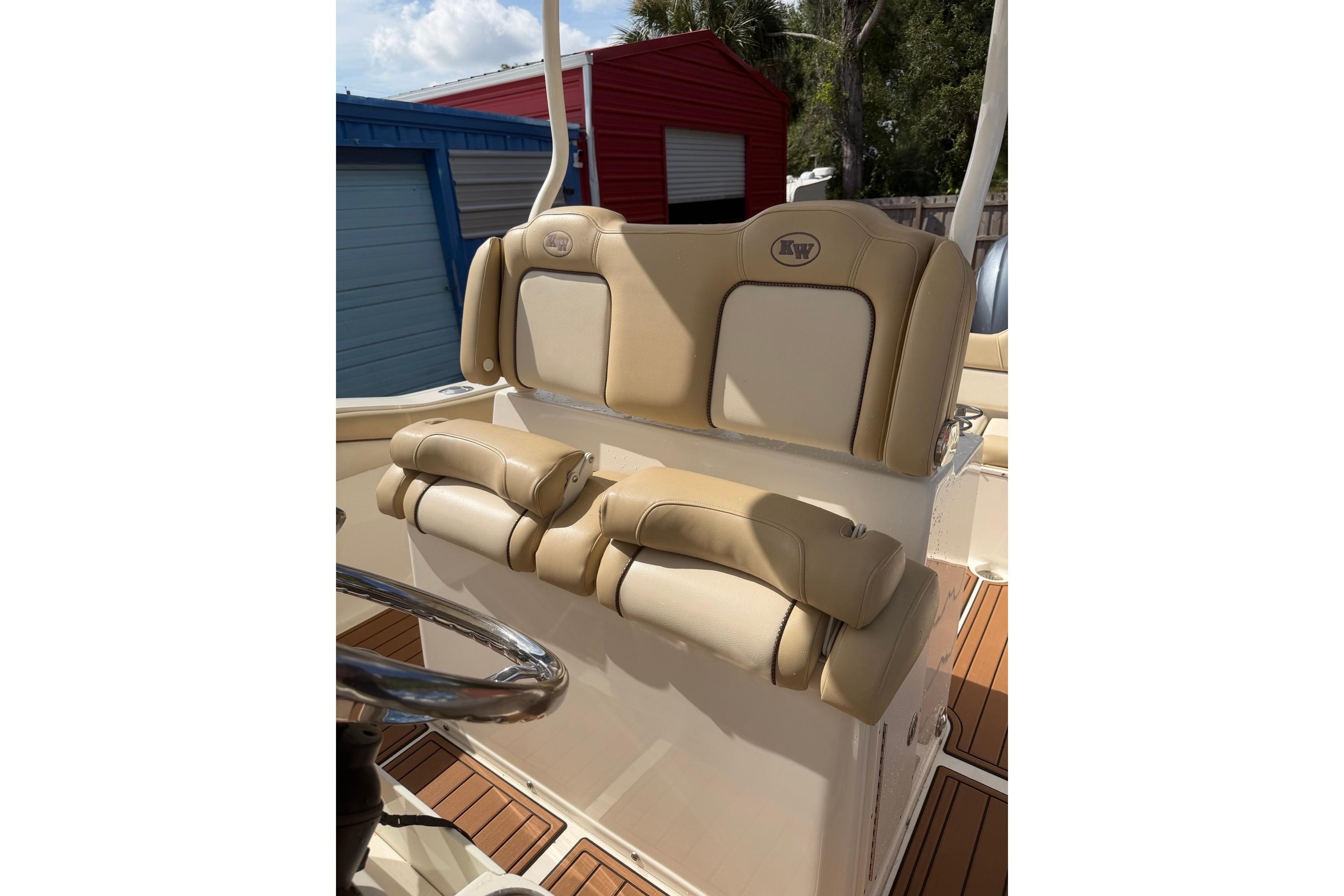 2019 Key West 263 FS boat seating with tan upholstery and steering wheel.