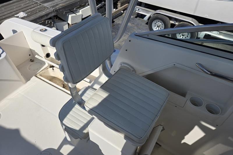 2004 Robalo R235 Walkaround boat interior with white seating and cup holders.