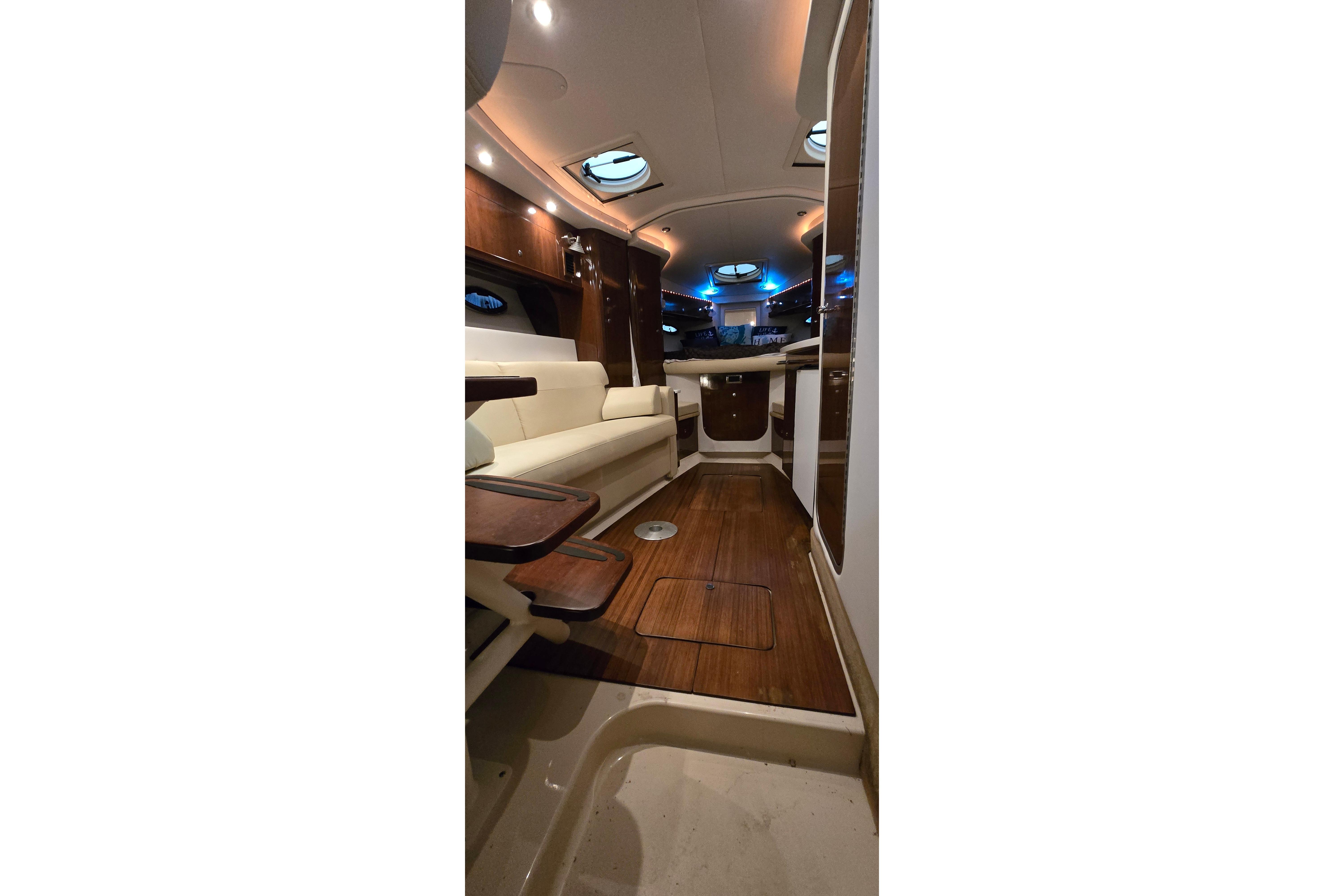 Interior of 2018 Four Winns V355 yacht with elegant wood and leather furnishings.