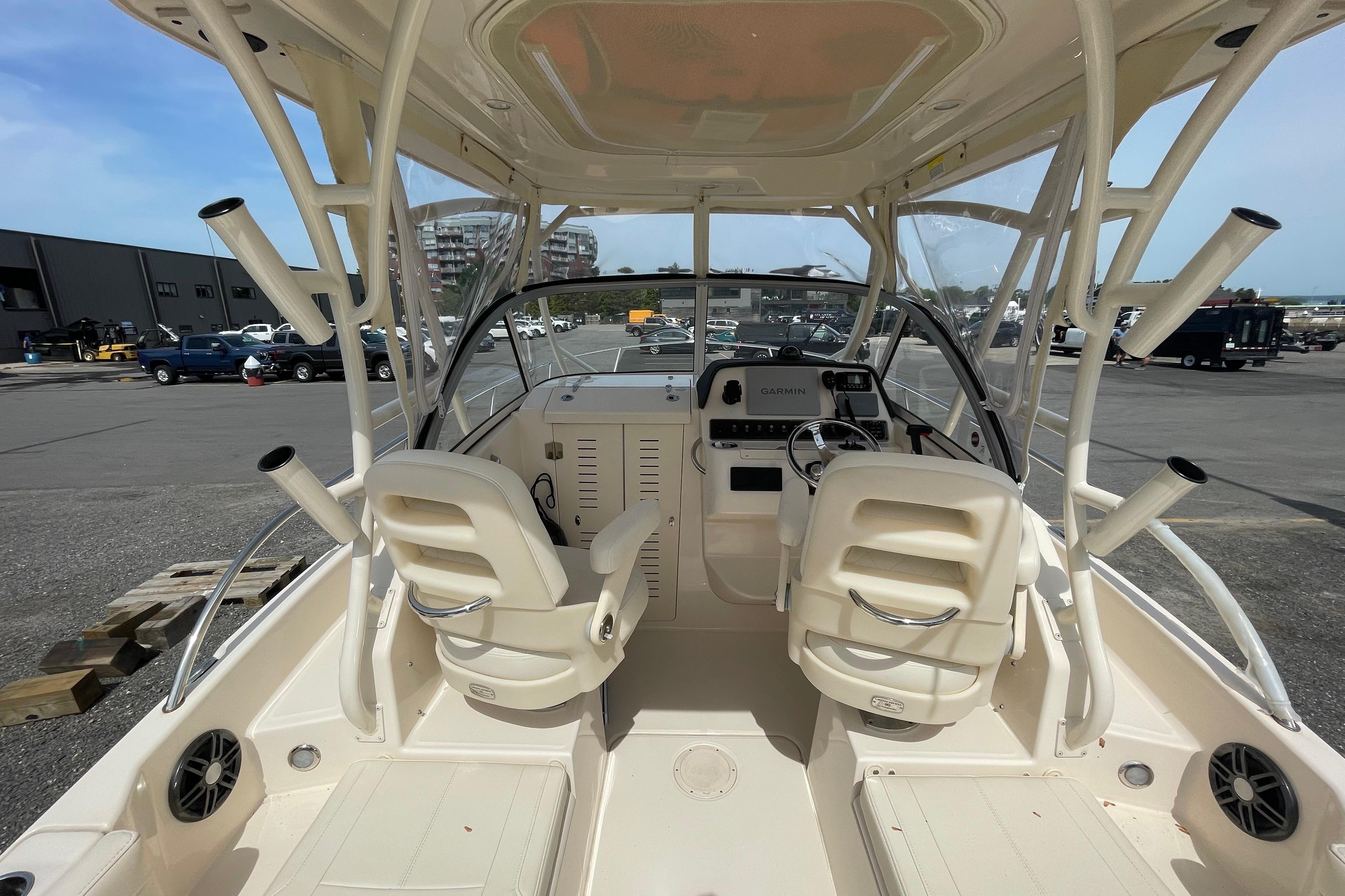 2024 Grady-White Adventure 218 boat interior with helm and seating, docked at marina.