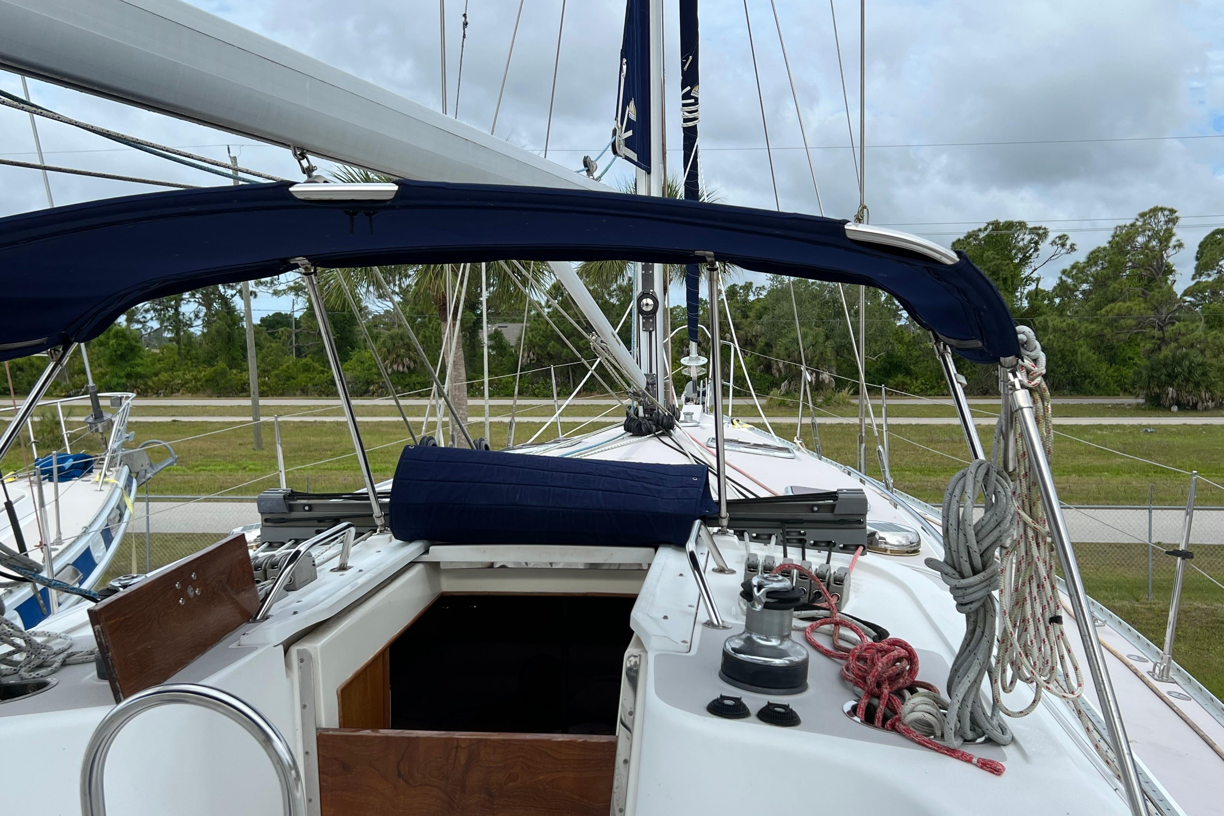 2008 Catalina 470 sailboat deck with ropes and canopy, docked outdoors.