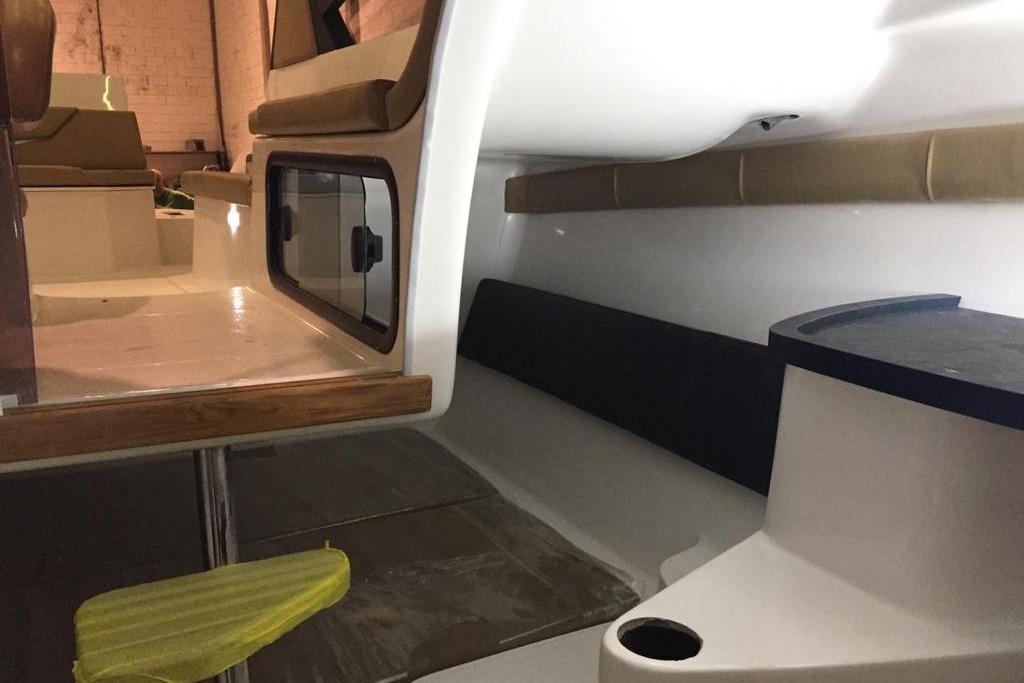 Interior of 2026 Hanover 305 boat, featuring seating and storage compartments.