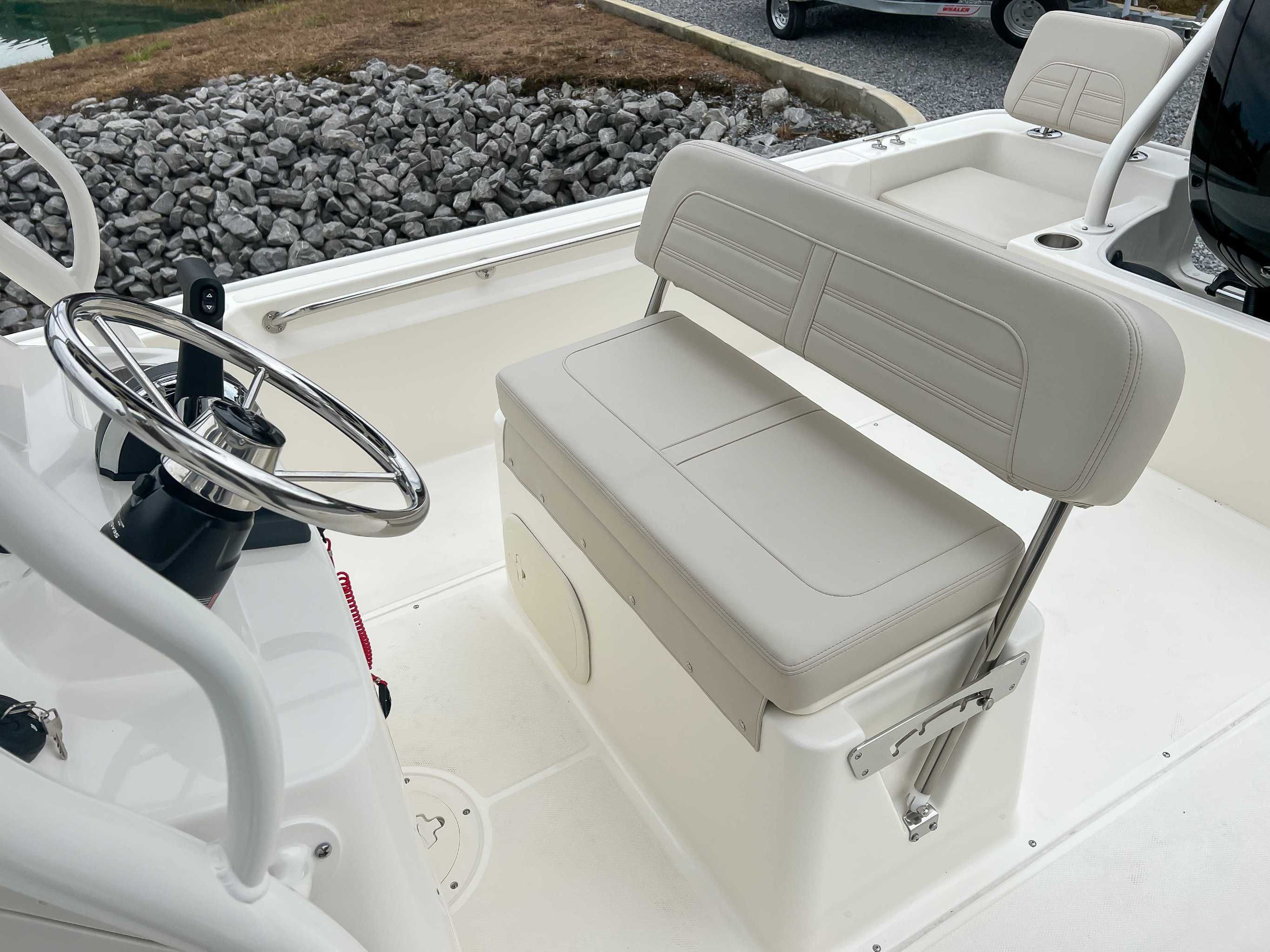 Interior of 2025 Boston Whaler 190 Montauk with steering wheel and bench seat.