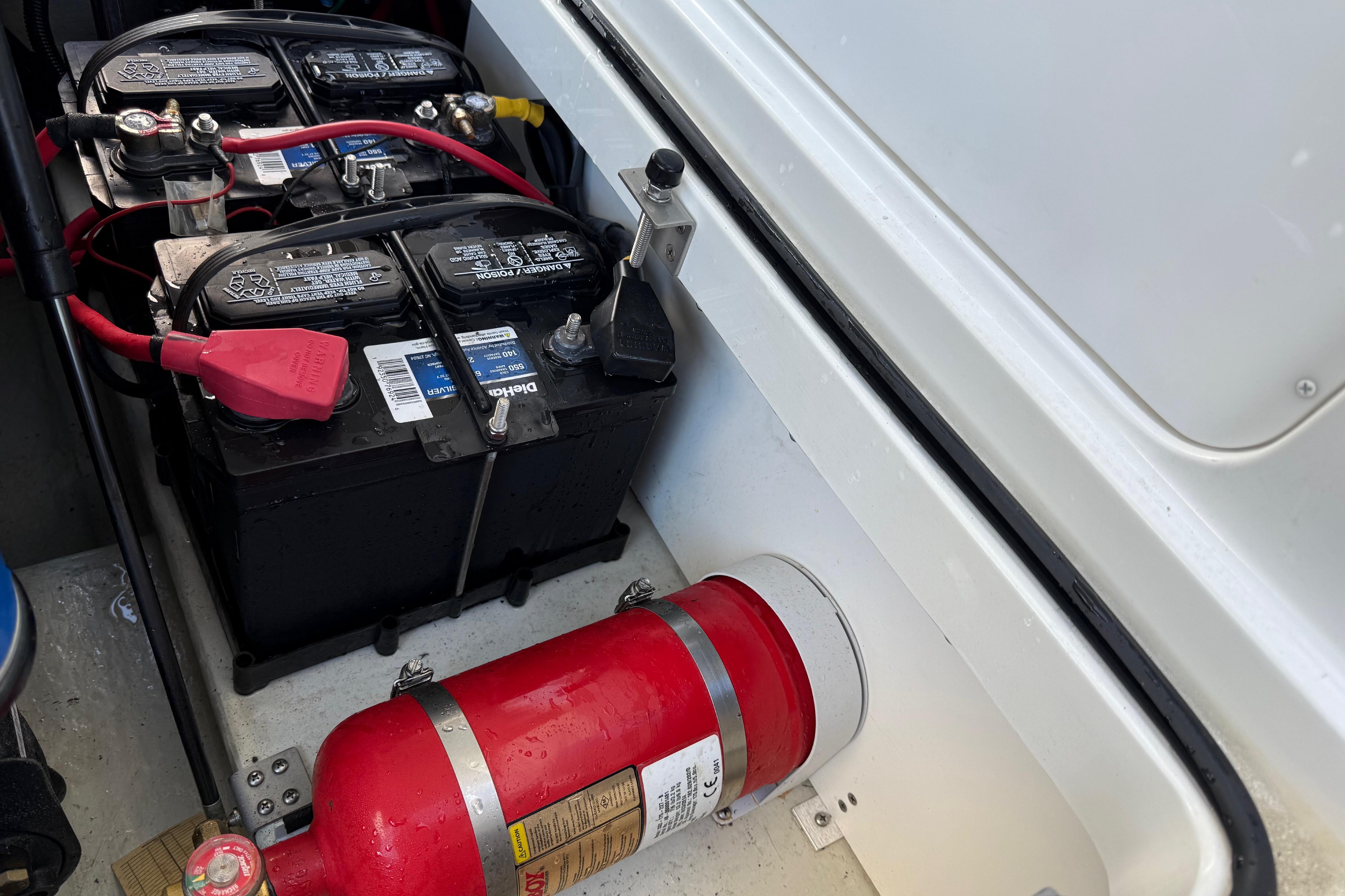 2015 Cobalt 200 boat battery compartment with fire extinguisher and dual batteries.