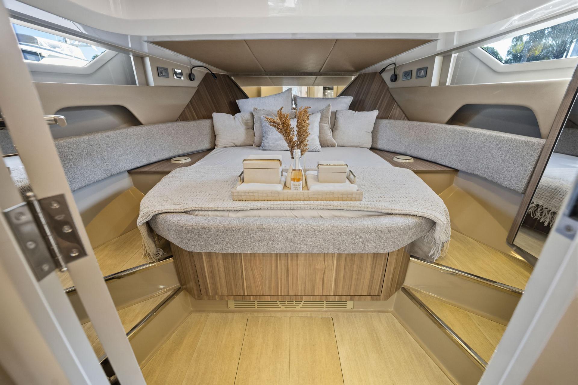 Luxurious interior of 2026 Hanover 447 yacht with elegant bedding and modern design.