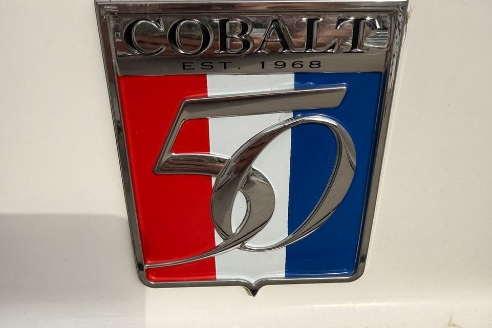 Cobalt 50th anniversary emblem on 2018 R5 WSS Surf boat, featuring red, white, and blue design.