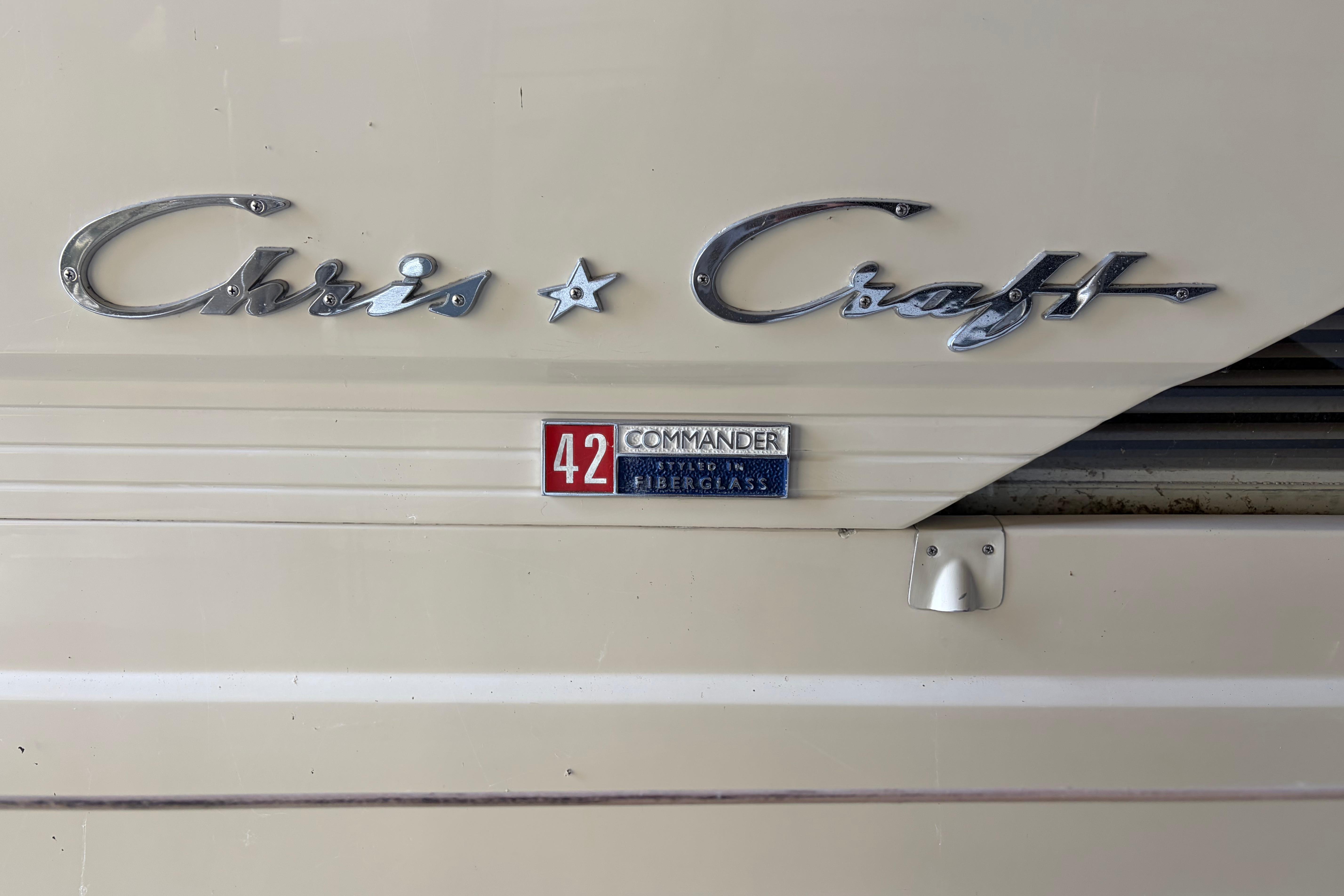 1971 Chris-Craft 42 Commander emblem on fiberglass boat exterior.