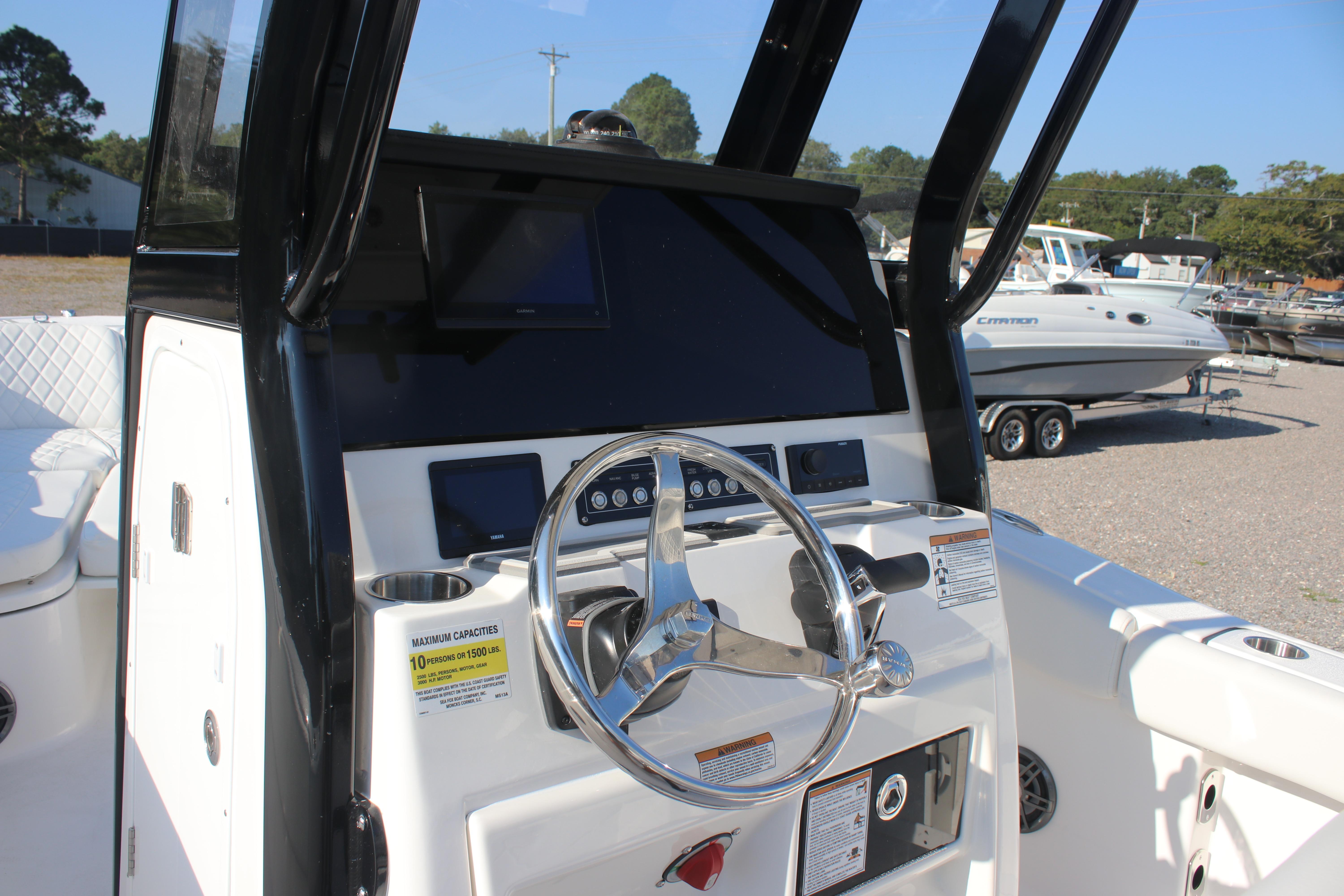 2026 Sea Fox 248 Commander boat console with steering wheel and control panel.