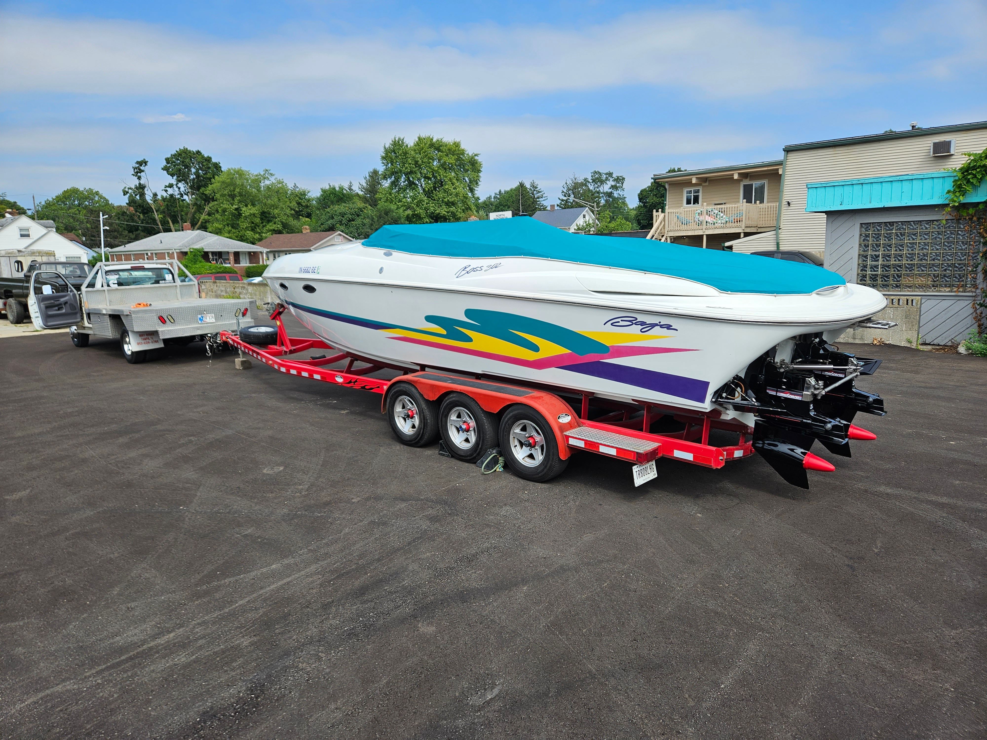 A 1996 Baja 302 Boss on a trailer, featuring colorful design and cover.