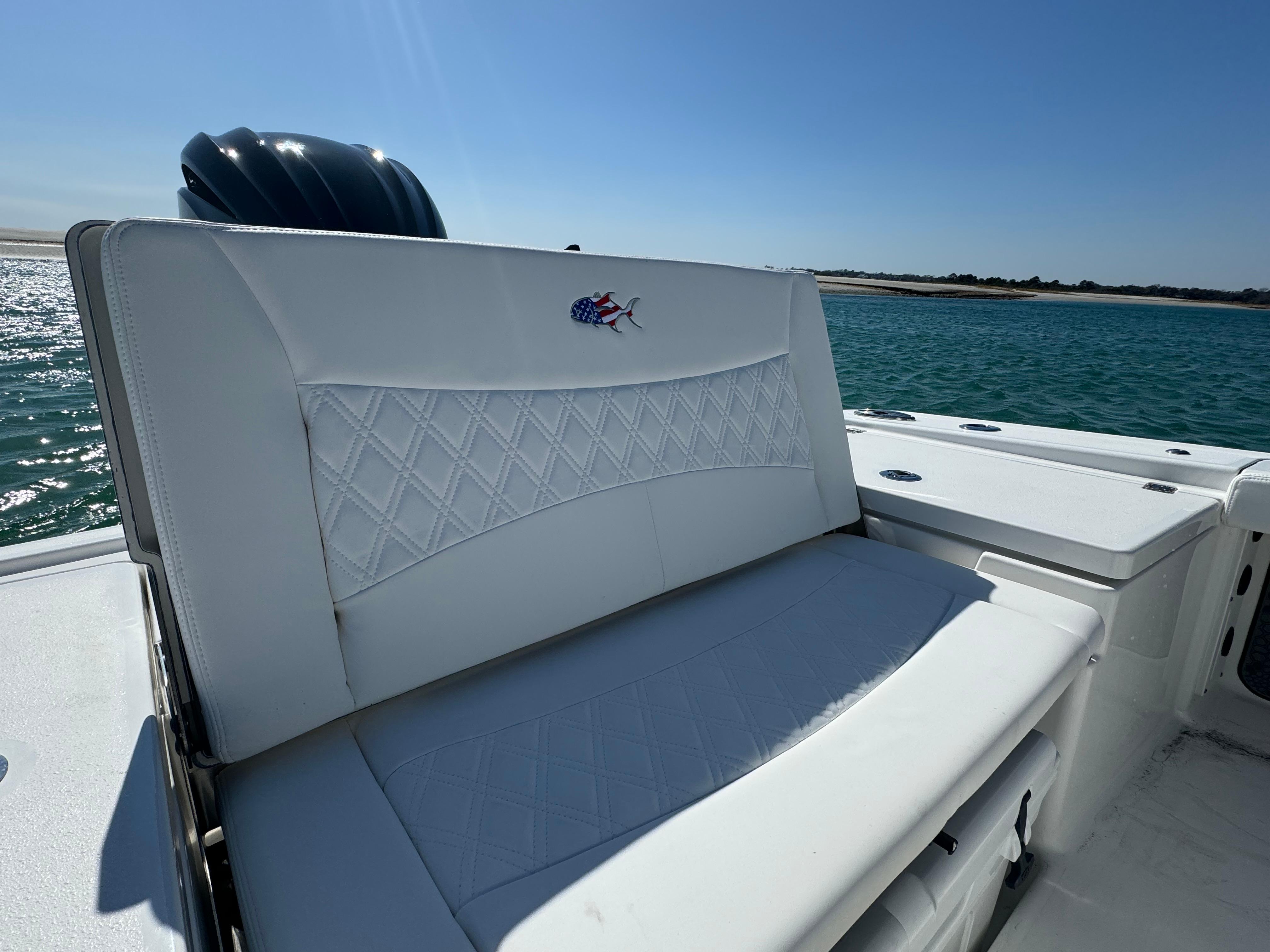 2025 Crevalle 24 HCO boat seat with embroidered logo, set against a sunny ocean backdrop.