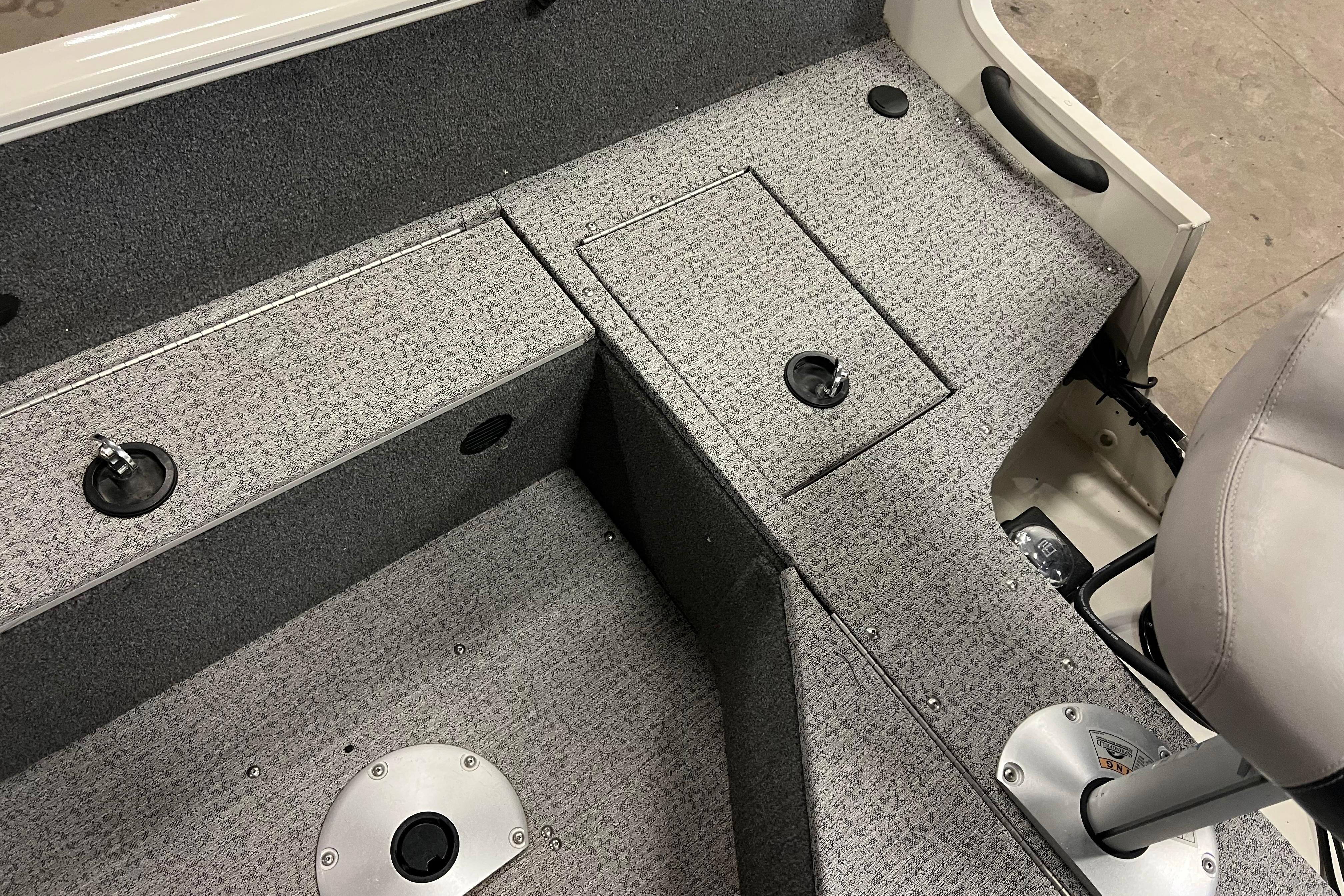 2022 Tracker Pro Guide V-16 WT boat interior with gray carpet and seating.