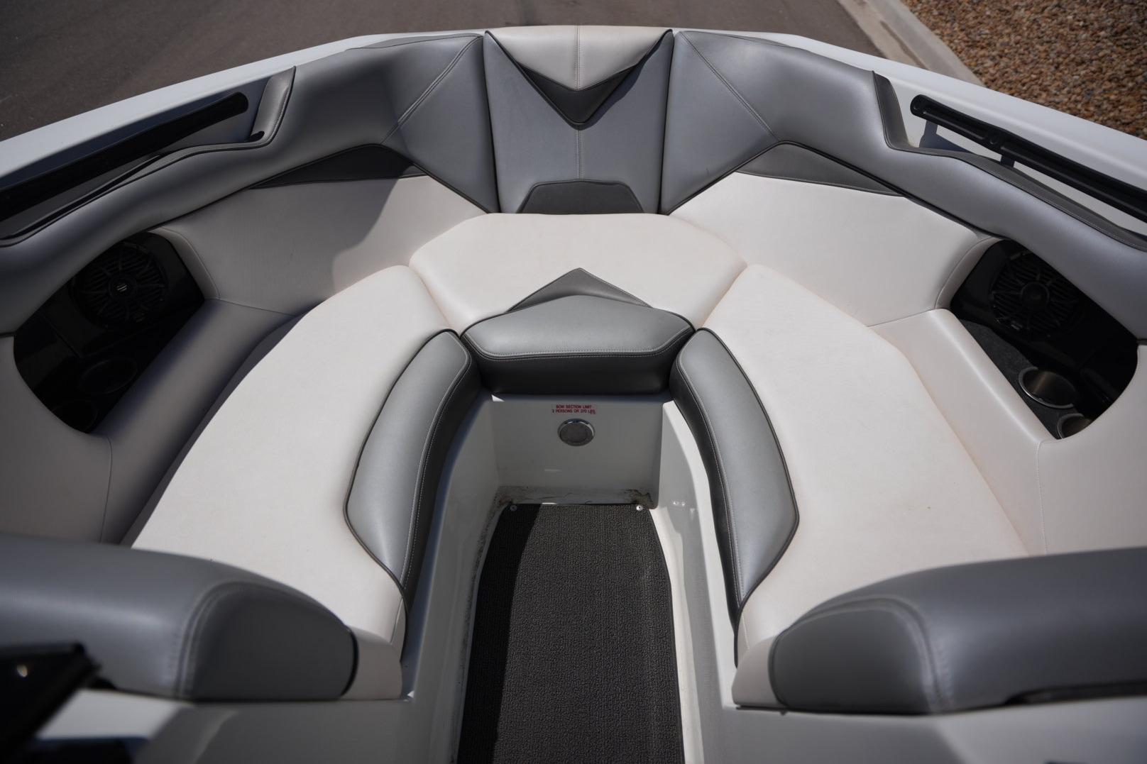 2016 Supreme S211 boat interior with gray and white seating.