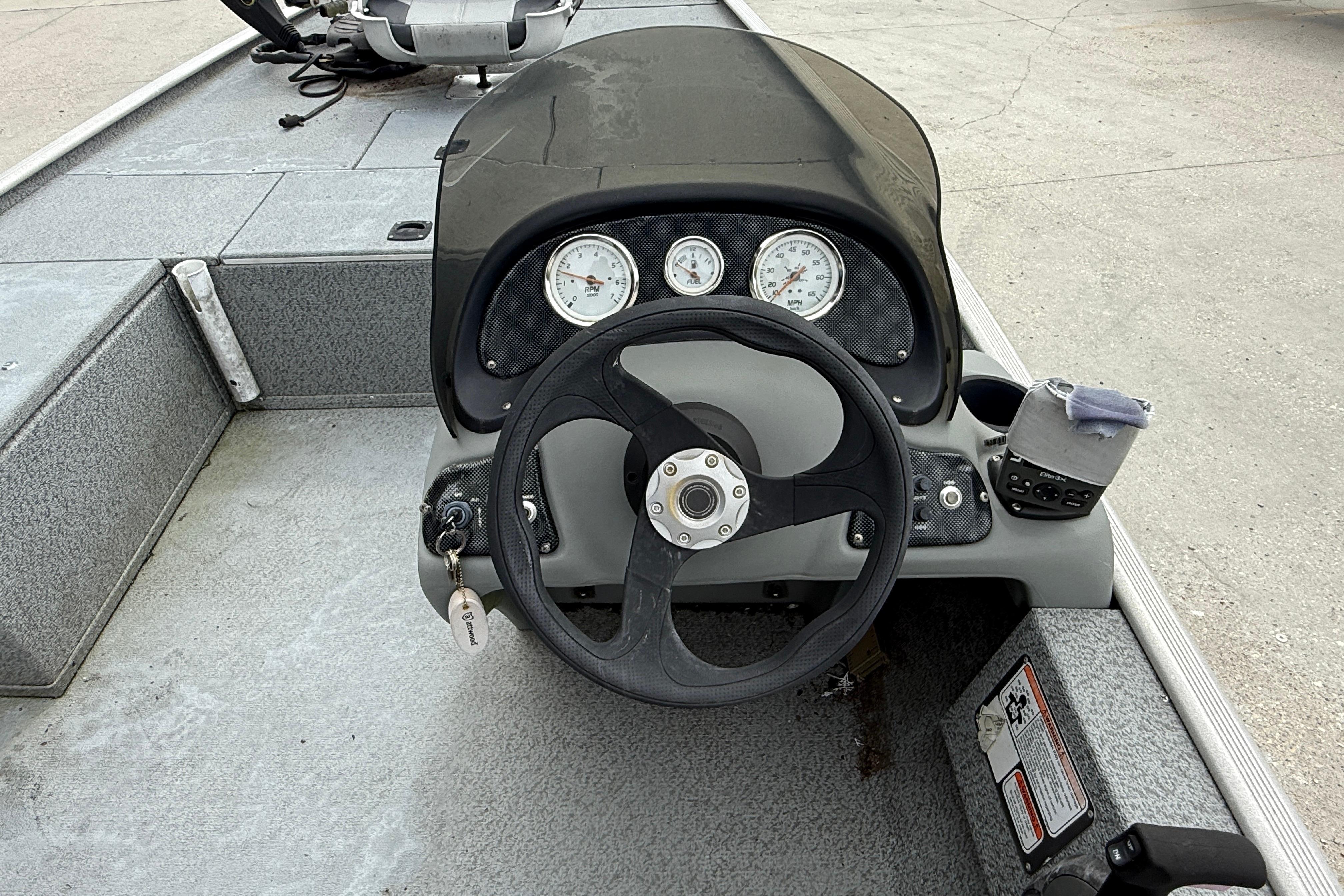 2016 Tracker Pro 170 boat dashboard with steering wheel and gauges.