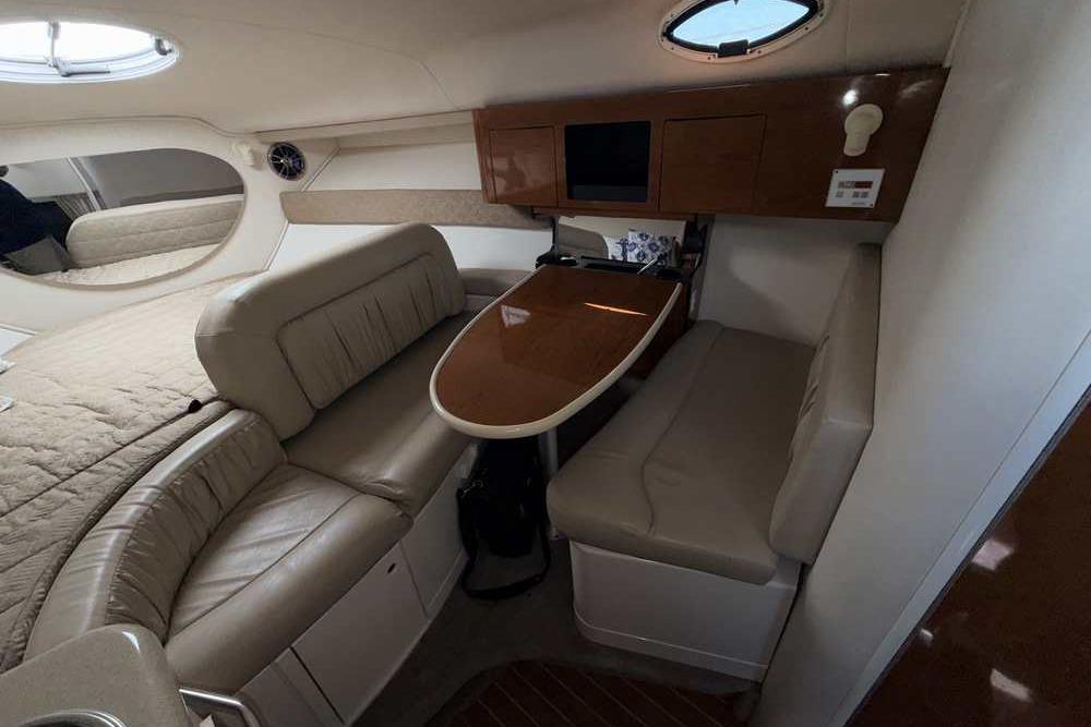 Interior of a 2001 Monterey 282 Cruiser with beige seating and wooden table.