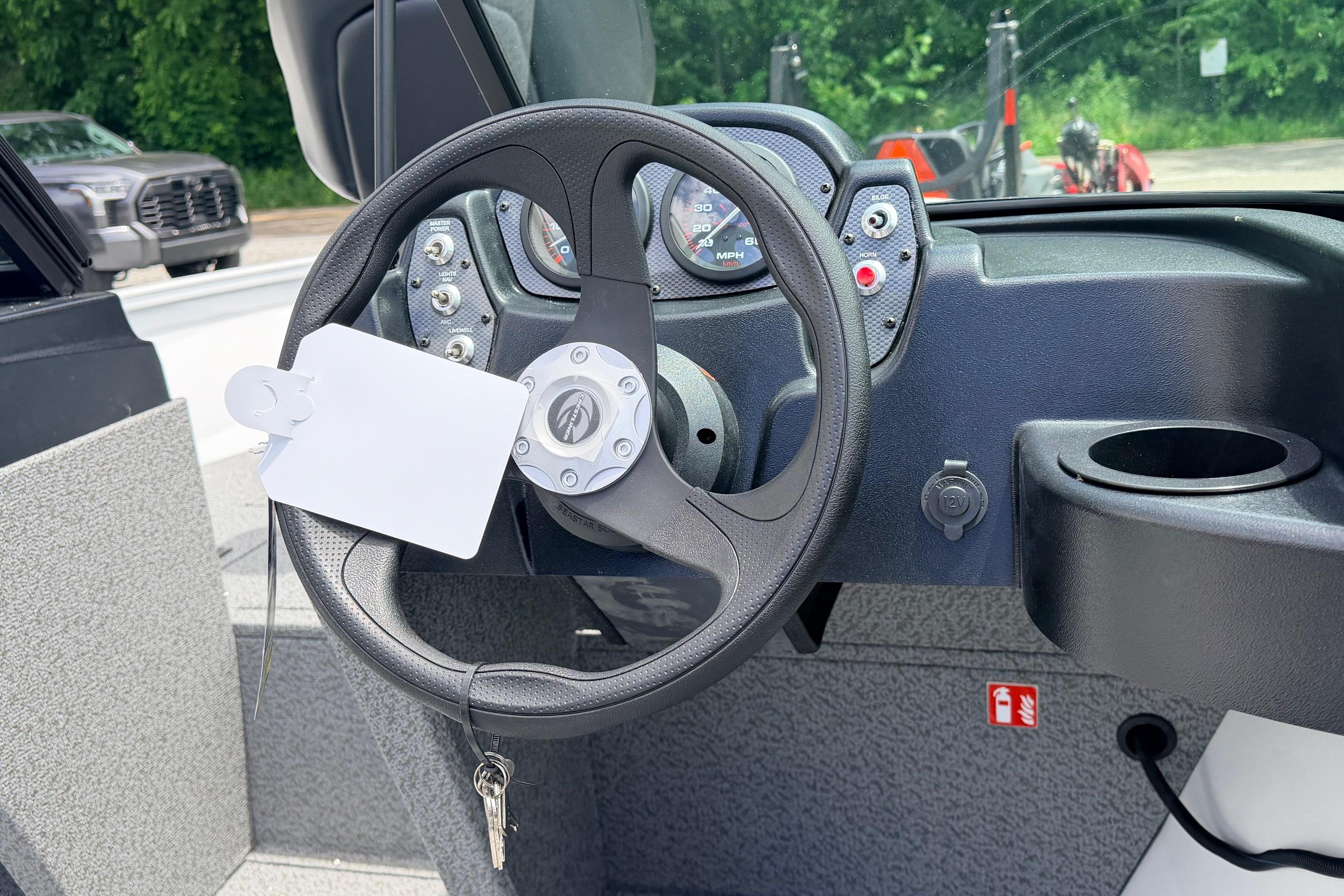 Steering wheel and dashboard of 2026 Crestliner 1650 Kodiak WT boat, featuring gauges and controls.