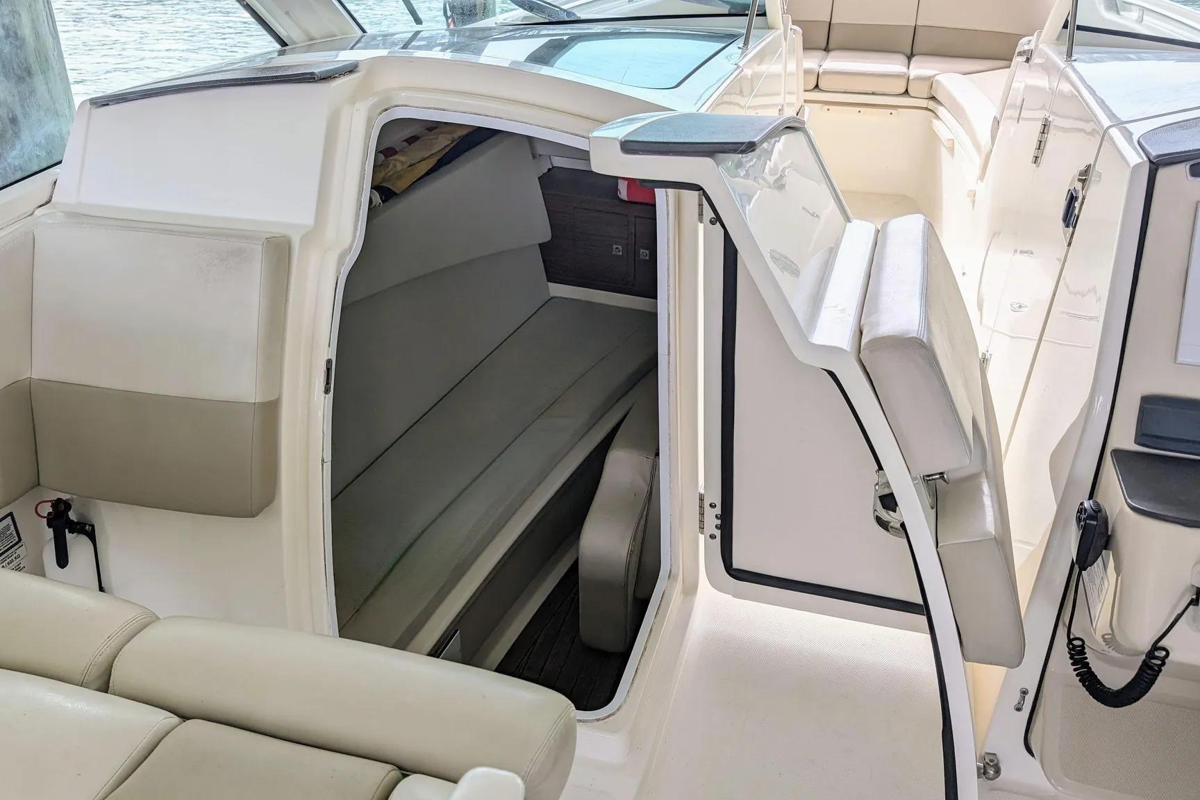 2017 Boston Whaler 320 Vantage interior cabin with seating and open door.