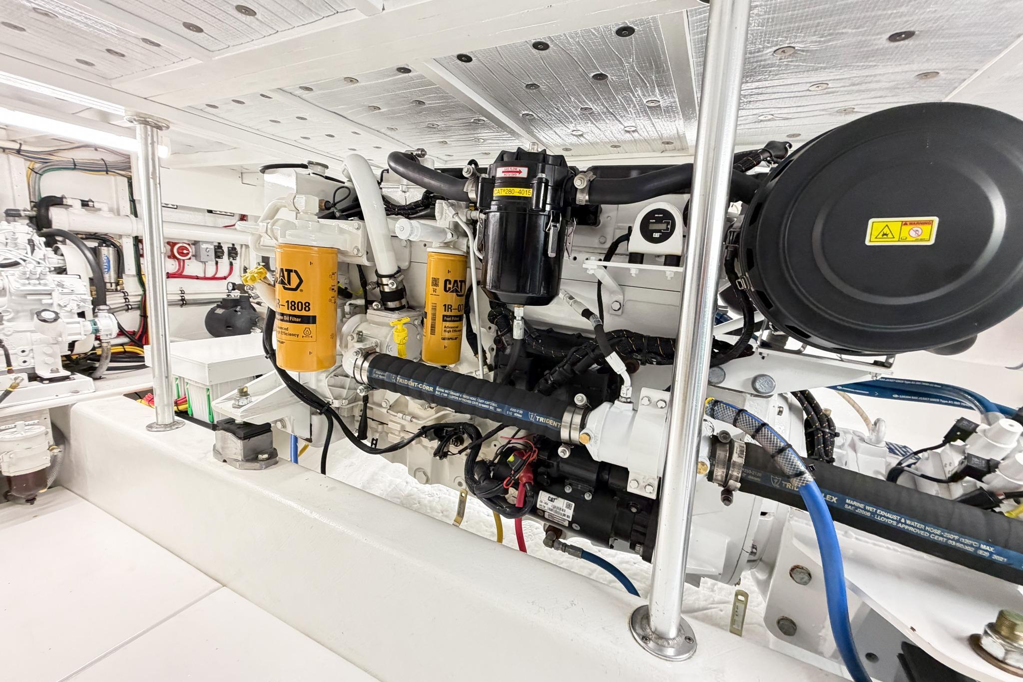 Engine room of 1998 Blackwell Custom Carolina Sportfish with CAT filters and machinery.