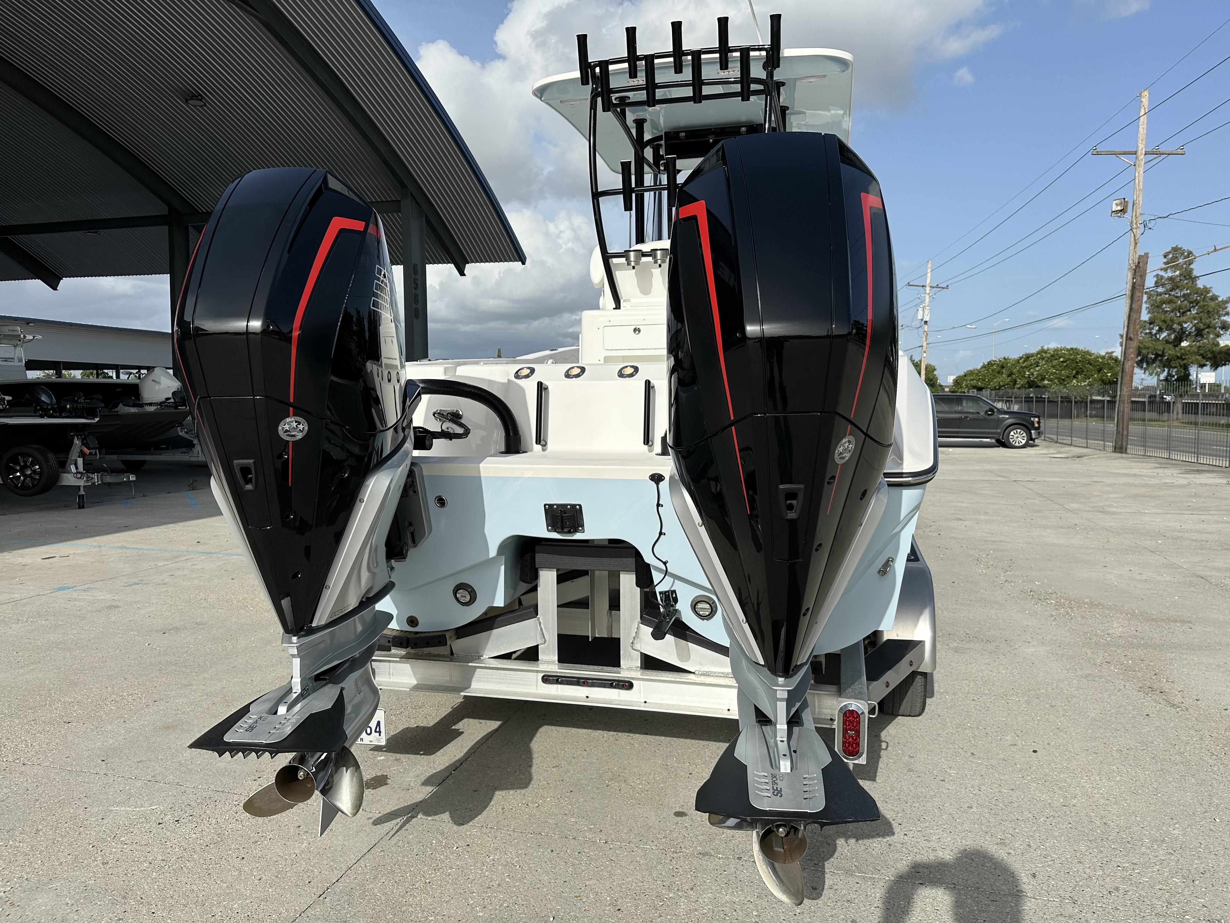 2023 Sea Cat 262 boat with dual outboard engines at a marina.