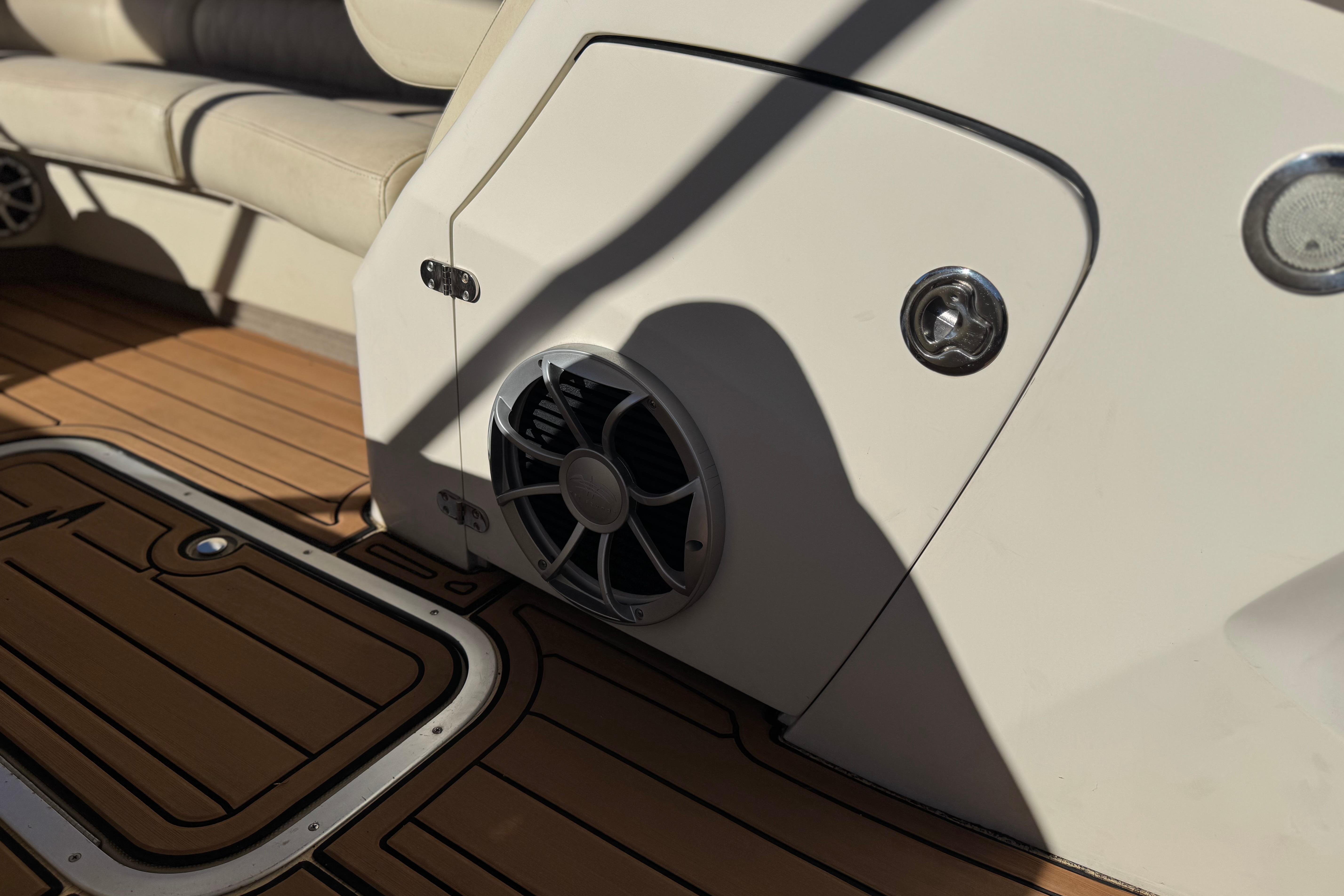 2013 Bennington 2575QCW I/O boat interior with speaker and teak flooring.