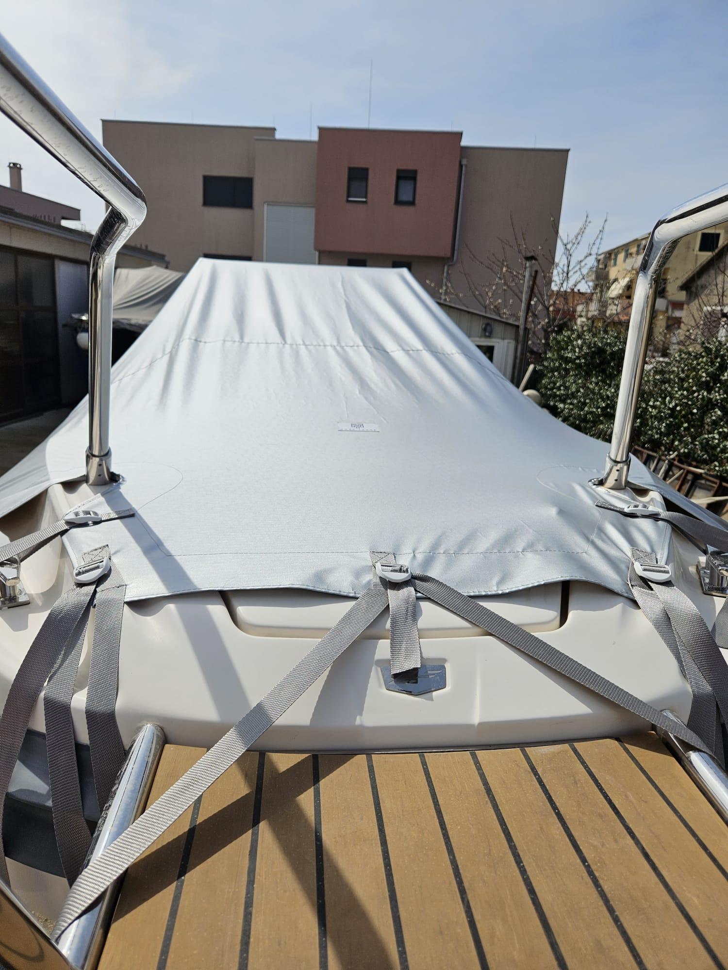 2020 Zar 85 SL boat with cover, docked in residential area.