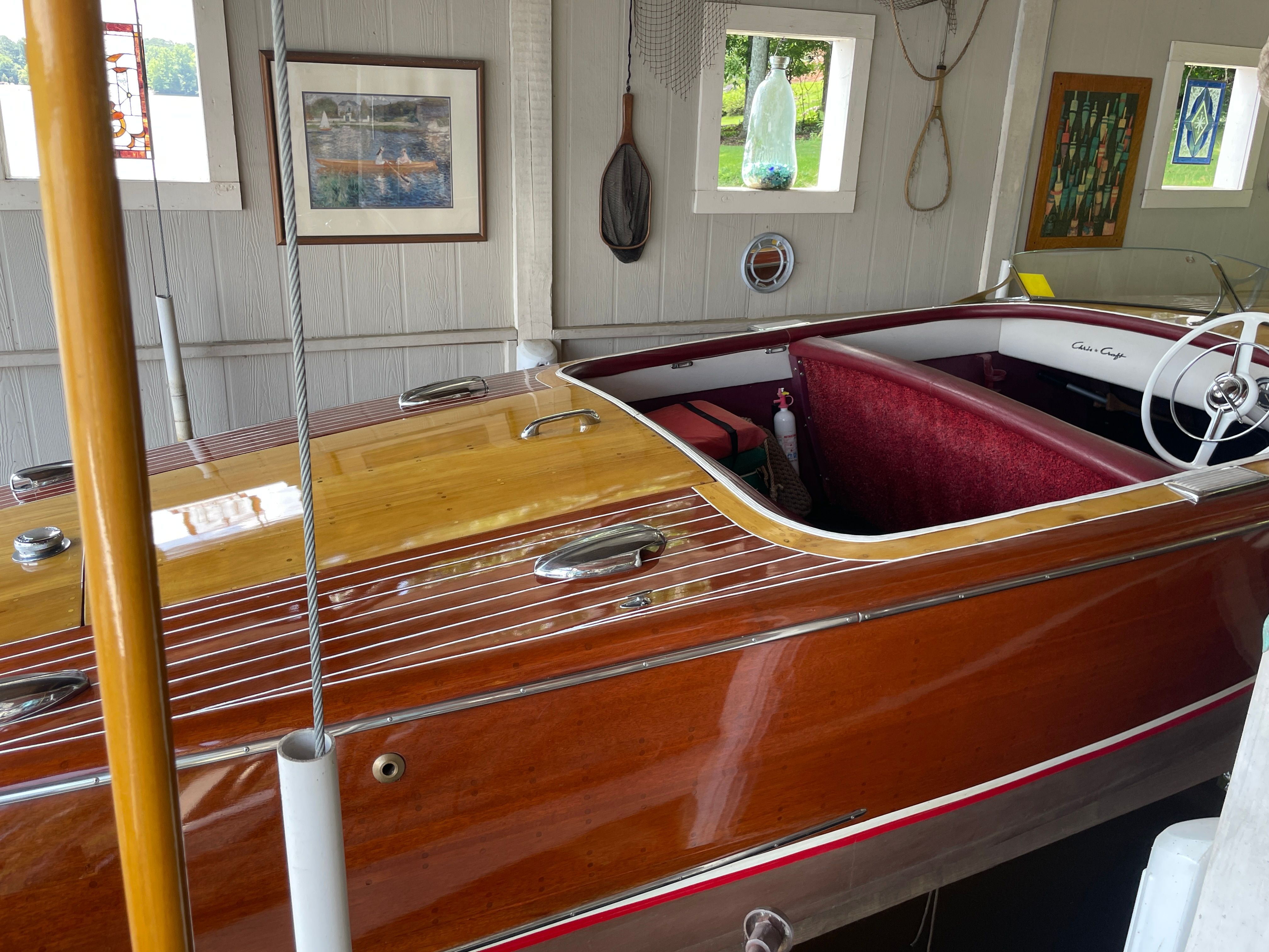1954 Chris-Craft Riviera wooden boat in a garage.