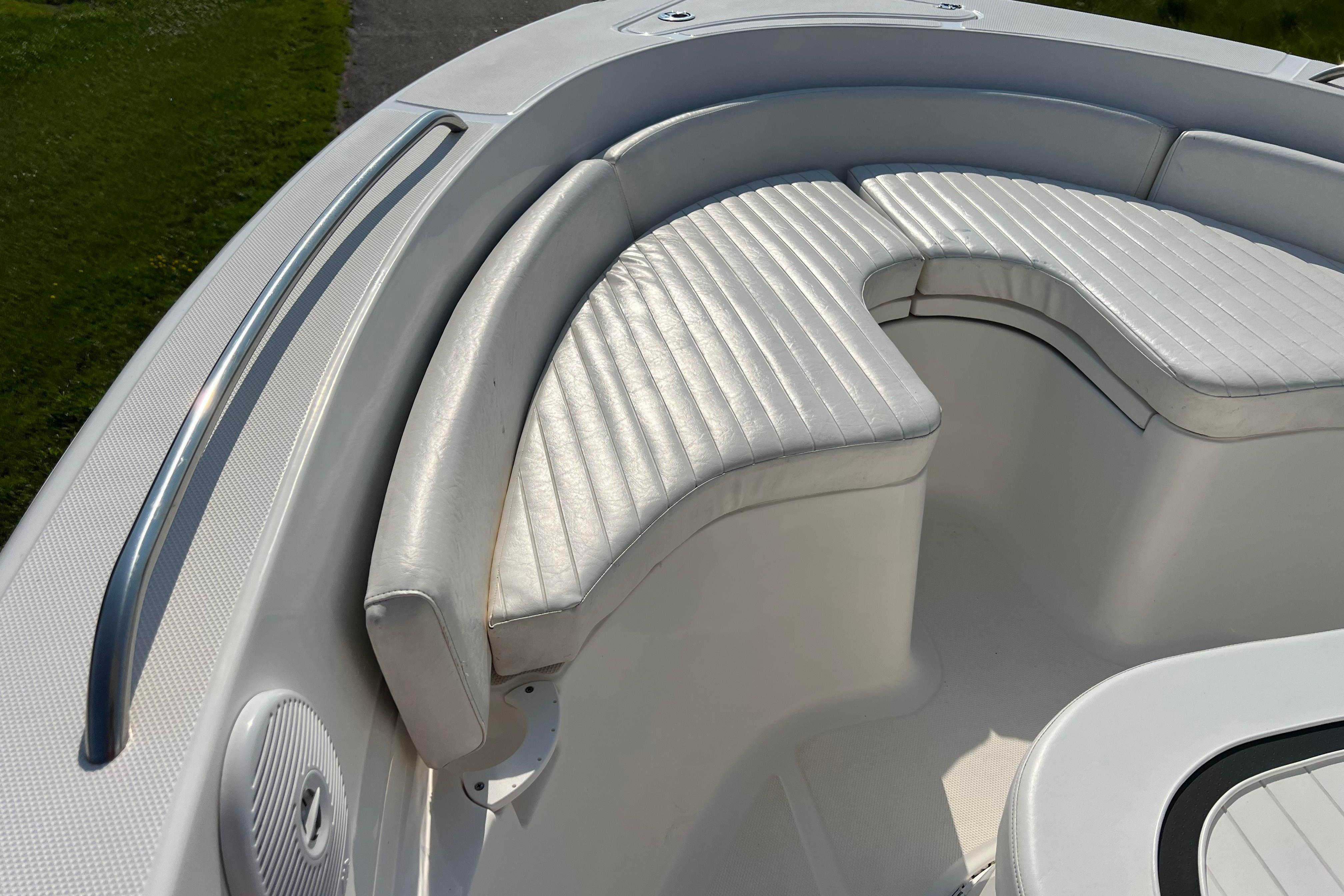 2012 Sea Fox 206 Center Console boat with white cushioned seating and stainless steel rail.