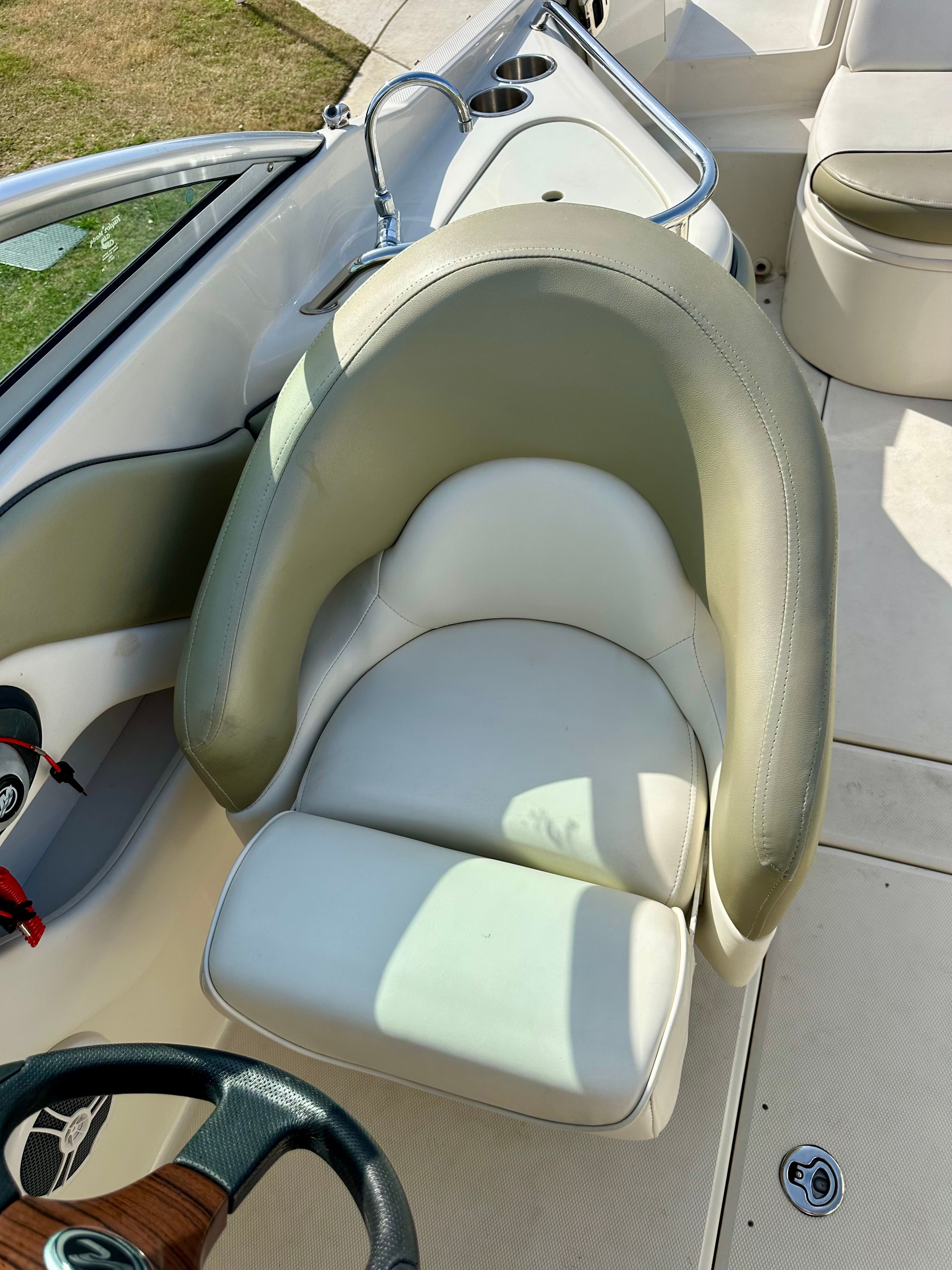 Interior of a 2006 Sea Ray 240 Sundeck with beige seating.