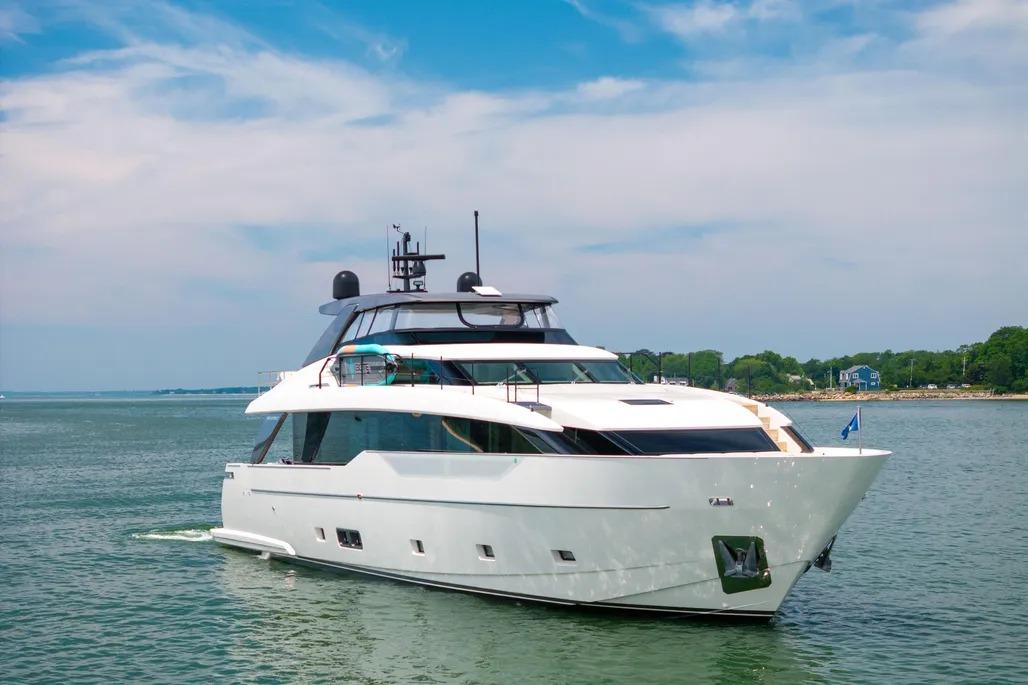 2024 Sanlorenzo SL90A yacht cruising on serene waters under a clear blue sky.