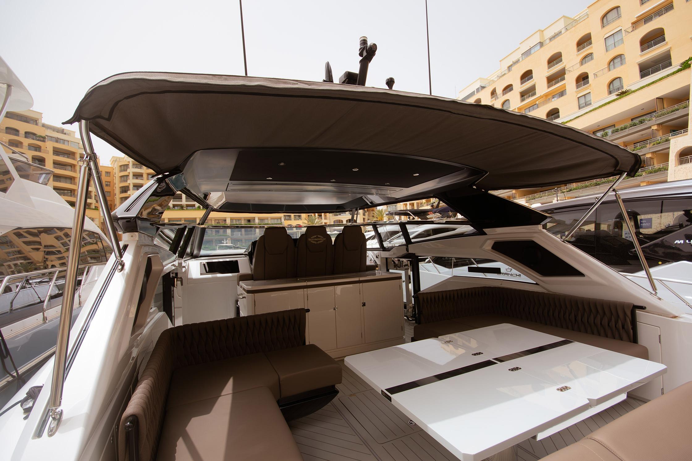 Luxurious 2024 Sunseeker Superhawk 55 yacht interior with elegant seating and dining area.