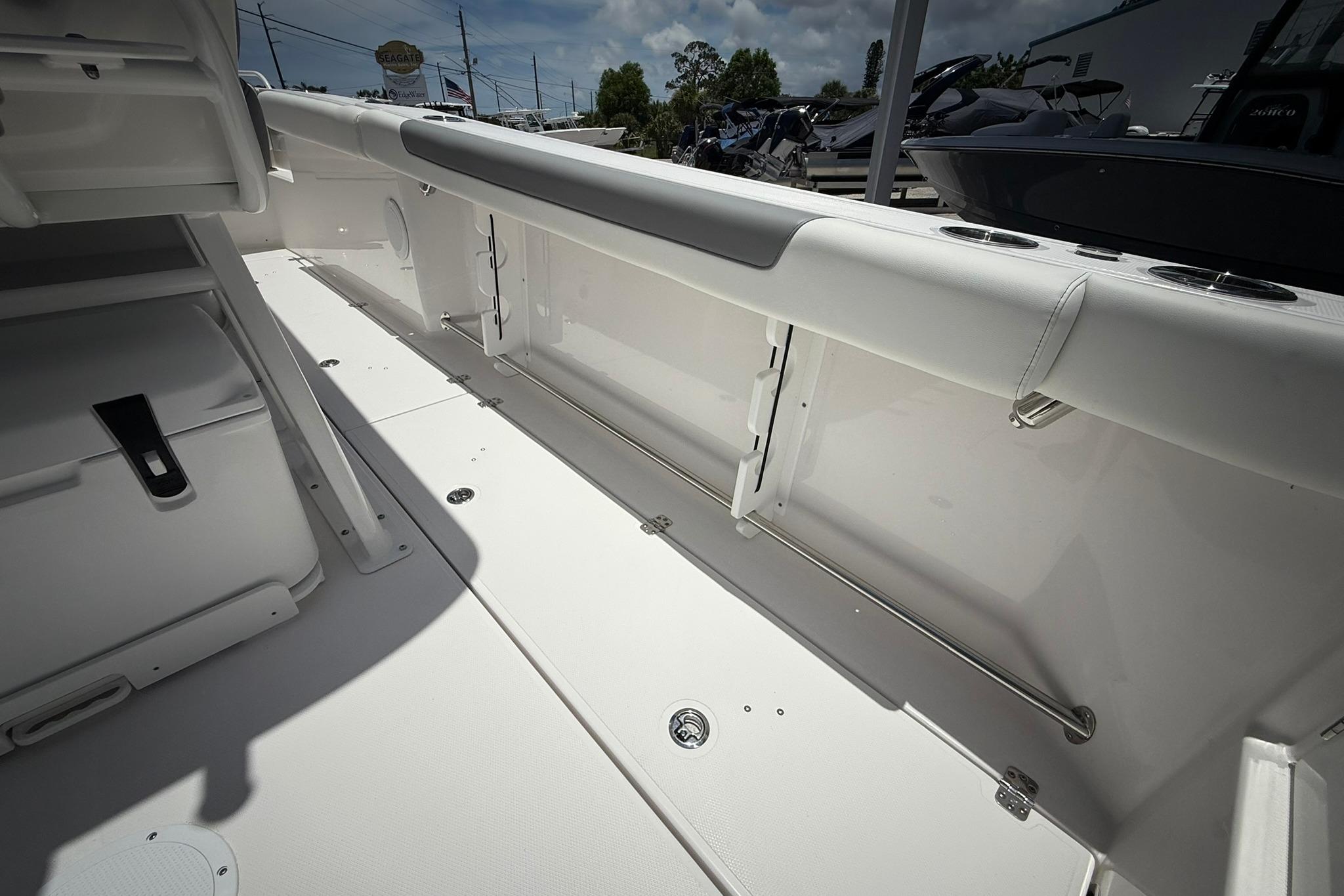 2026 Edgewater 250CC boat interior, featuring sleek white seating and storage compartments.