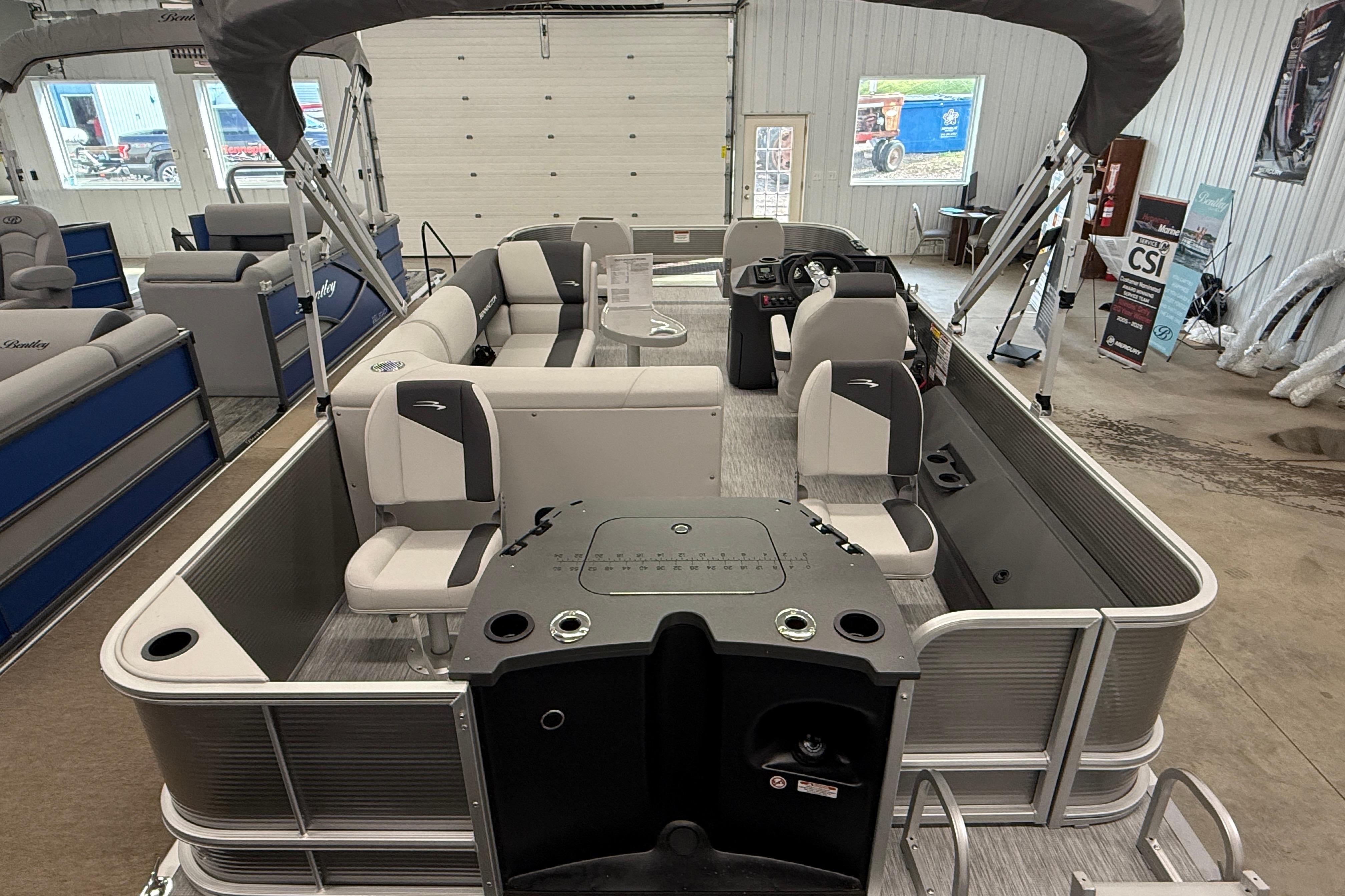 2026 Bennington 20 SF pontoon boat interior with seating and helm in showroom.